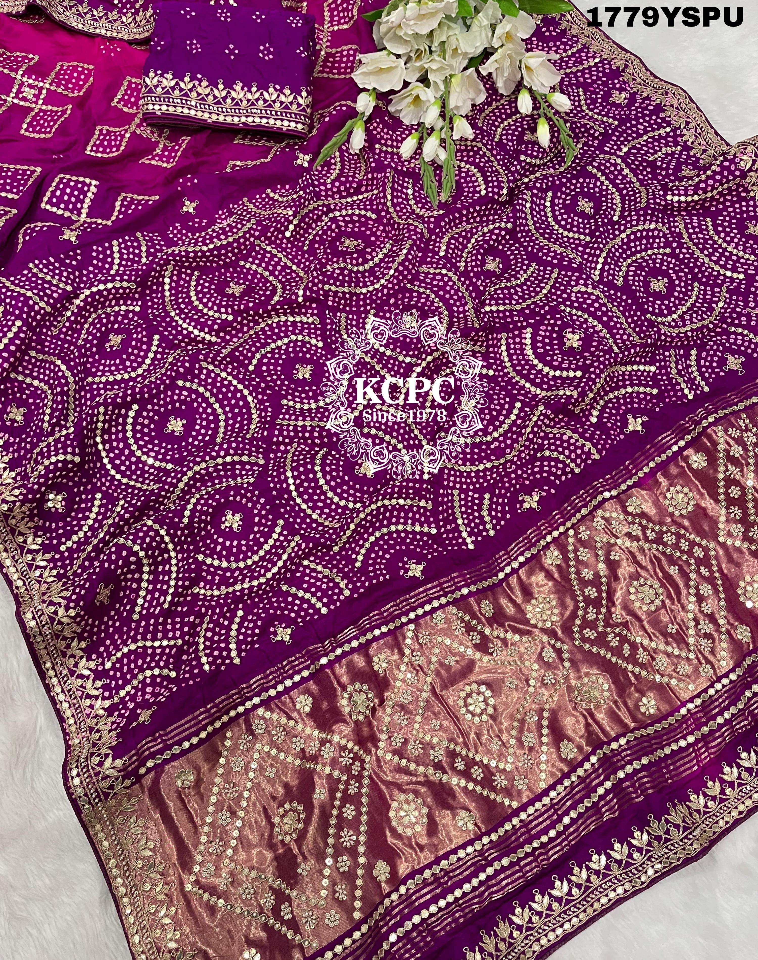 A purple and pink bandhani saree with heavy gotapatti work