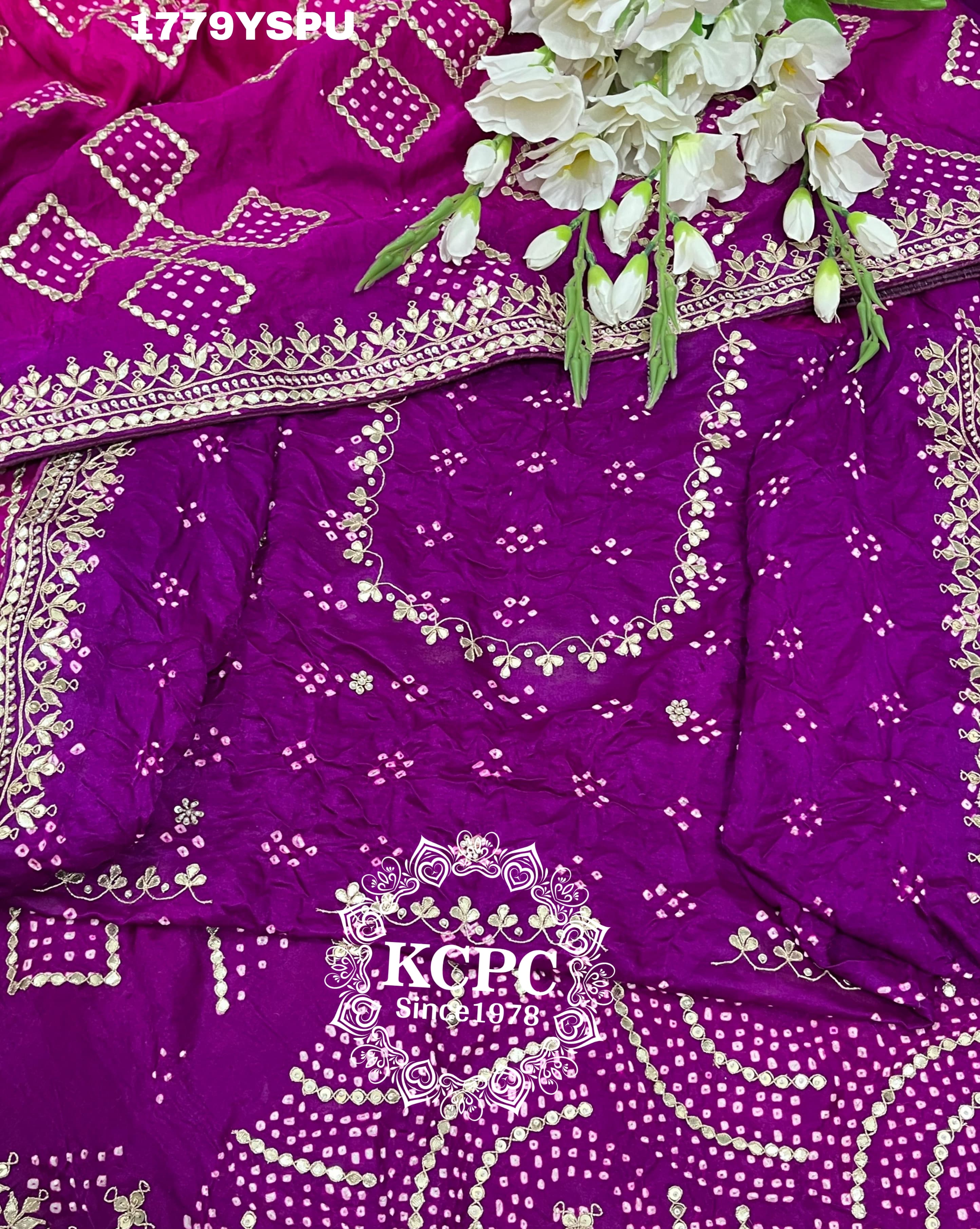 A purple and pink bandhani saree with heavy gotapatti work