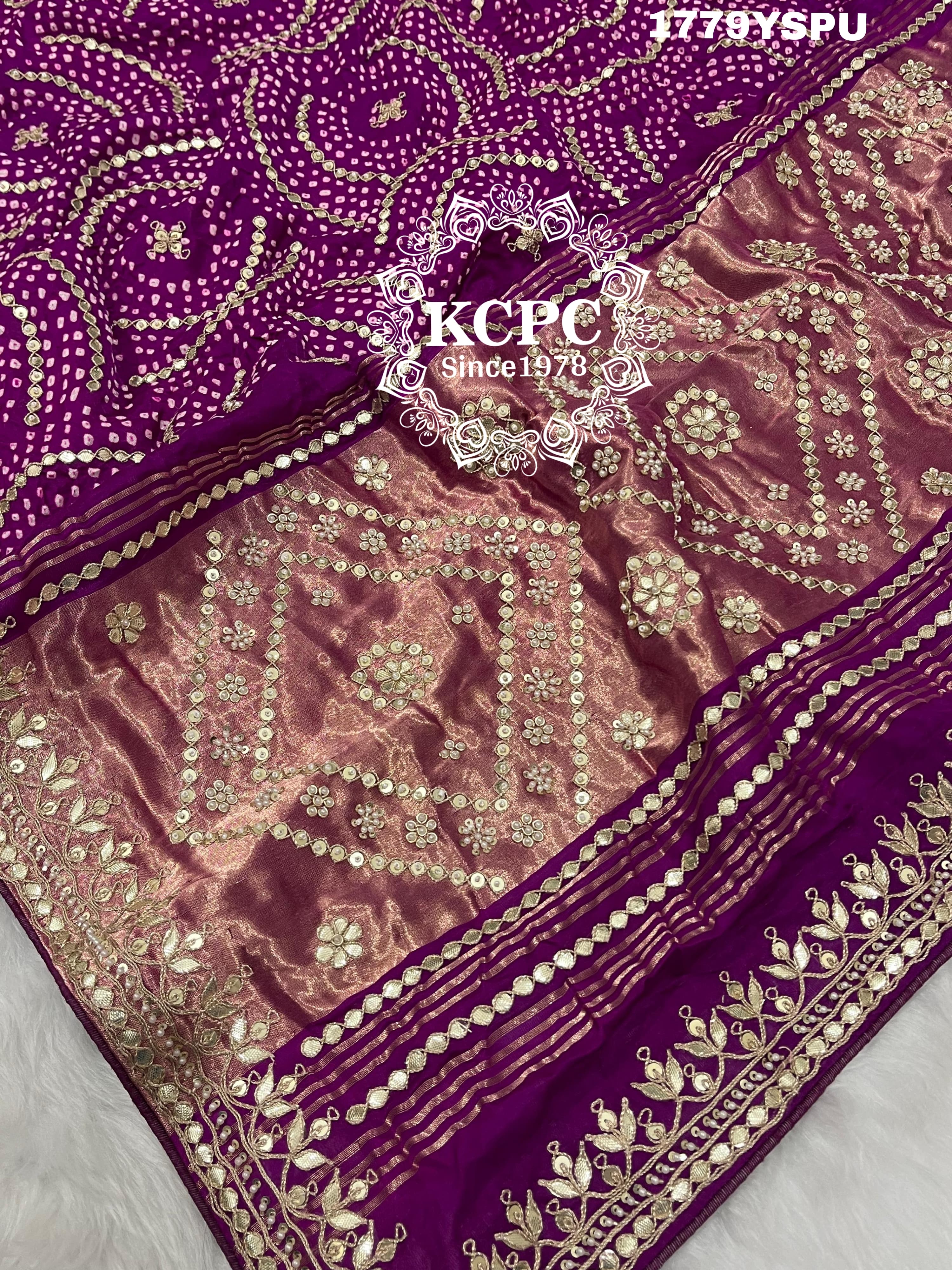 A purple and pink bandhani saree with heavy gotapatti work