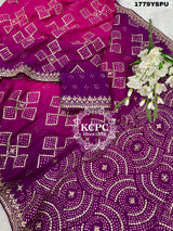 A purple and pink bandhani saree with heavy gotapatti work