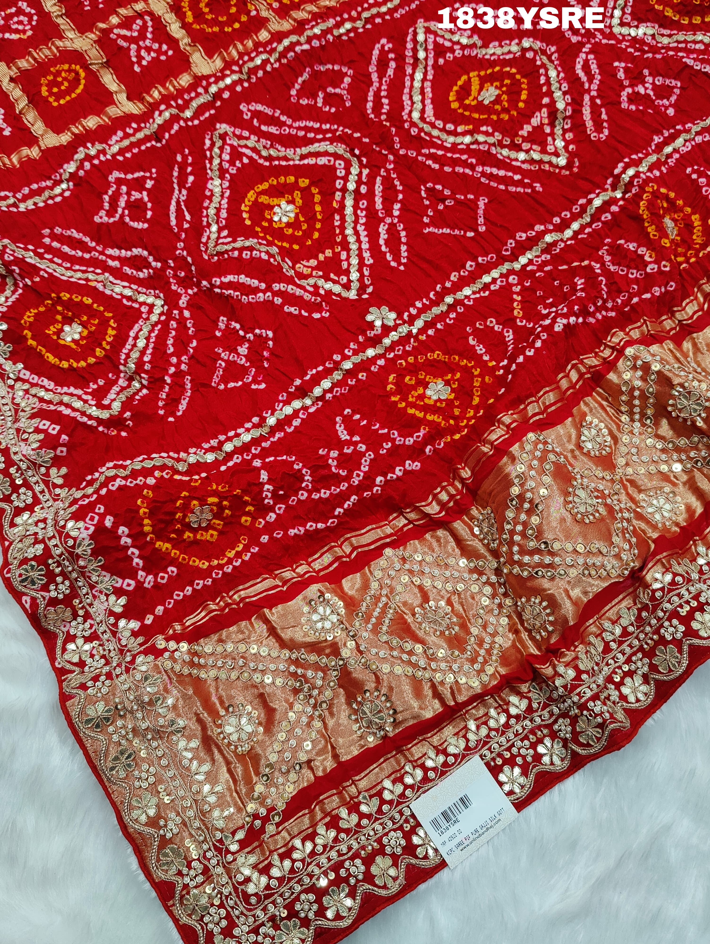 A red and gold saree with floral patterns and gota patti embellishments