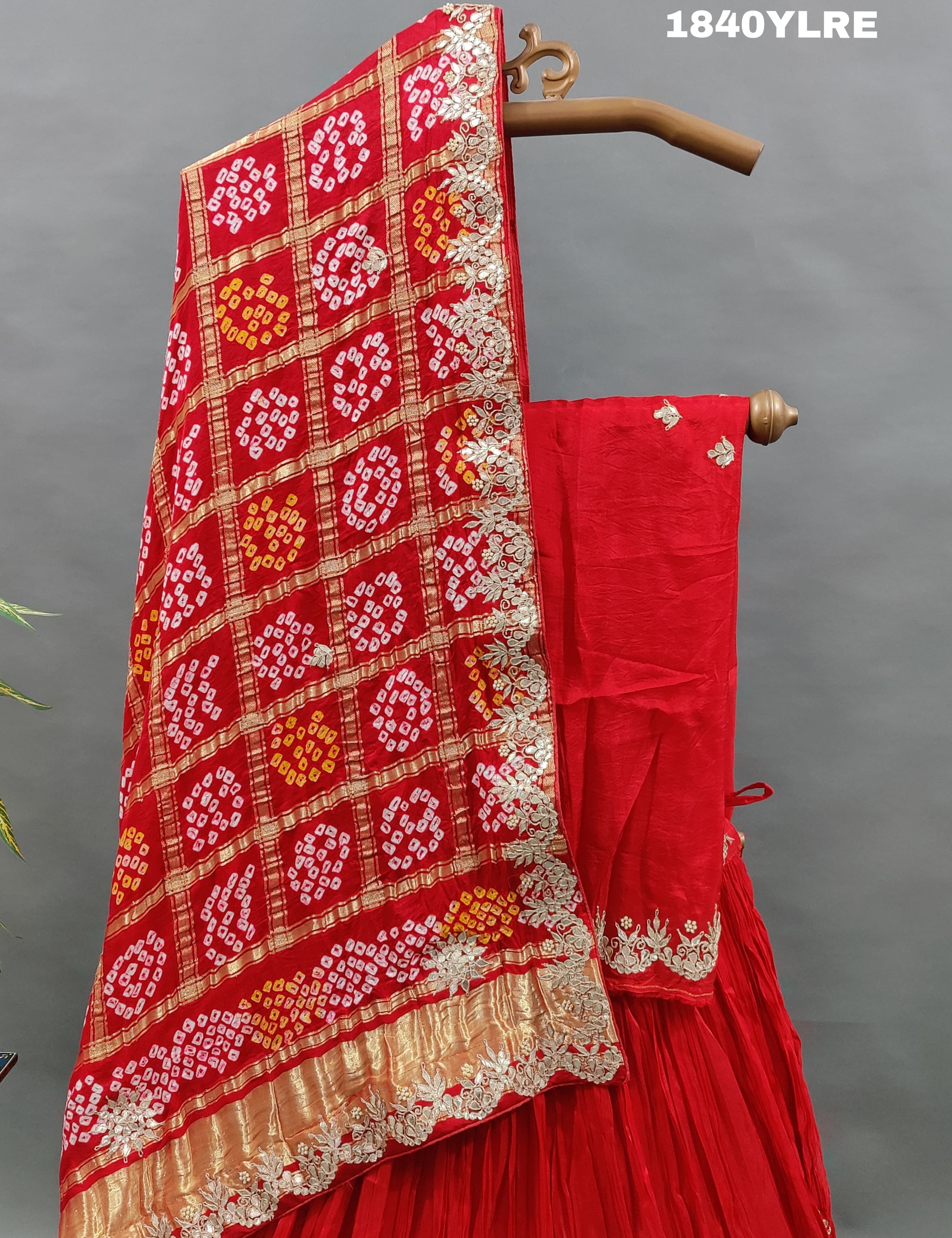 A red pure gaji silk lehenga with bandhani gharchola dupatta