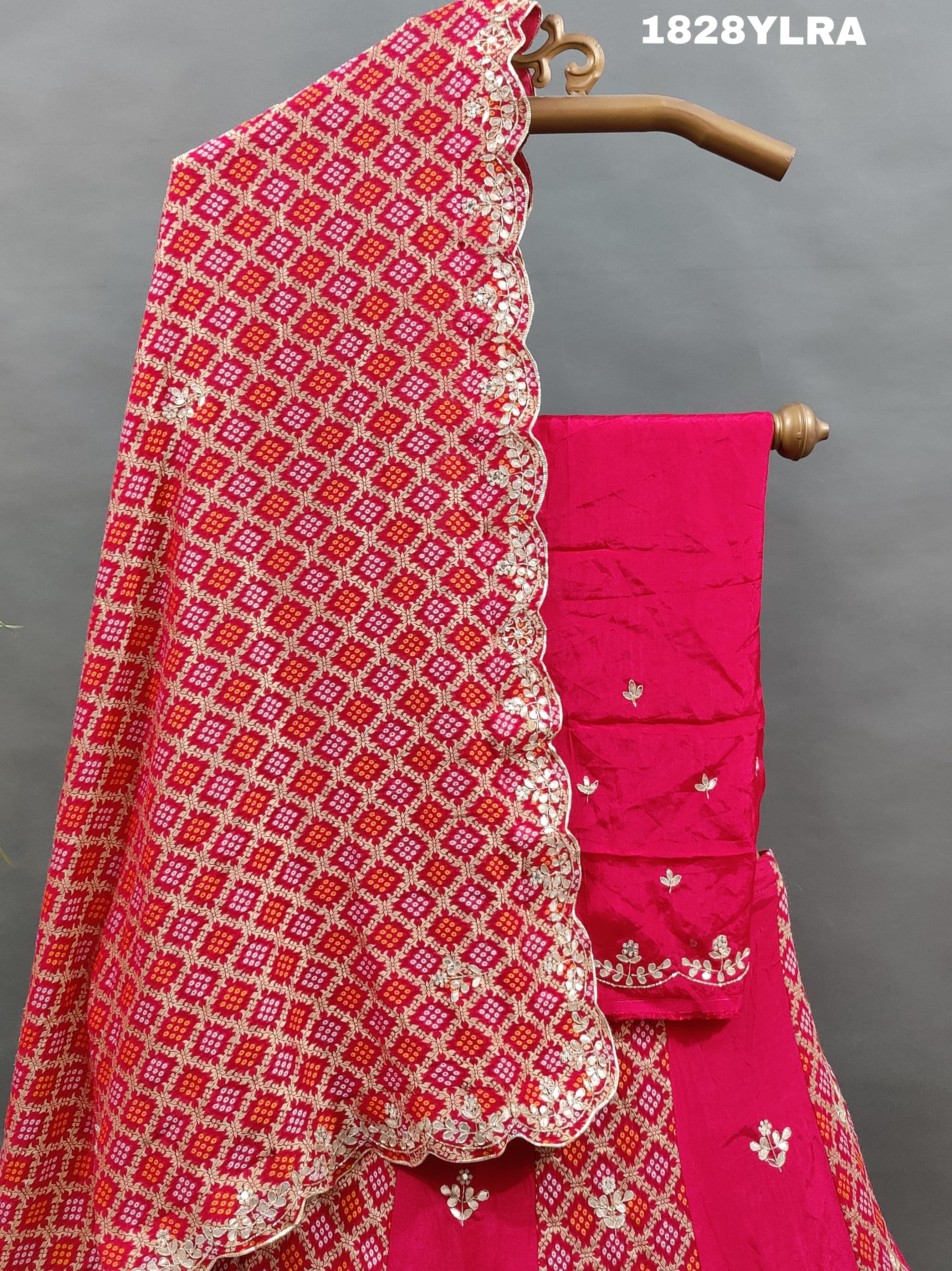 A traditional wear lehenga set with bandhani print and white bead work
