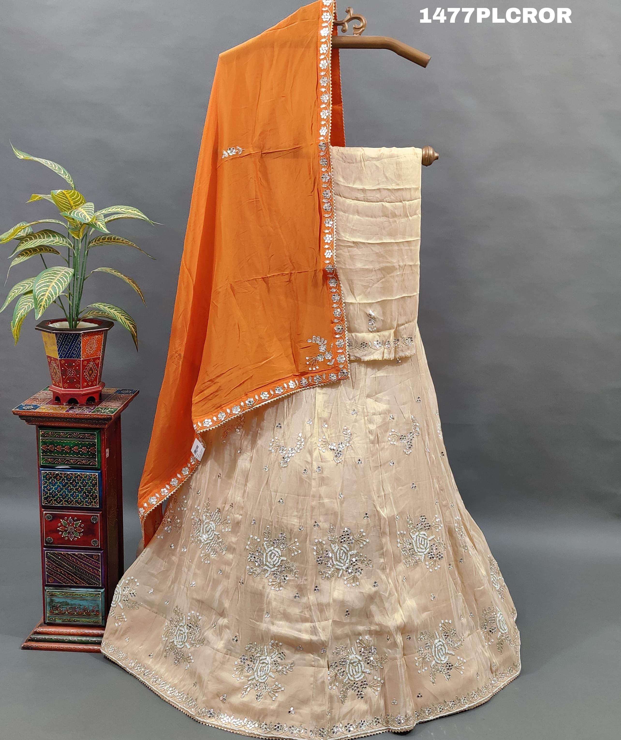 A traditional Indian lehenga with beige and orange colors.