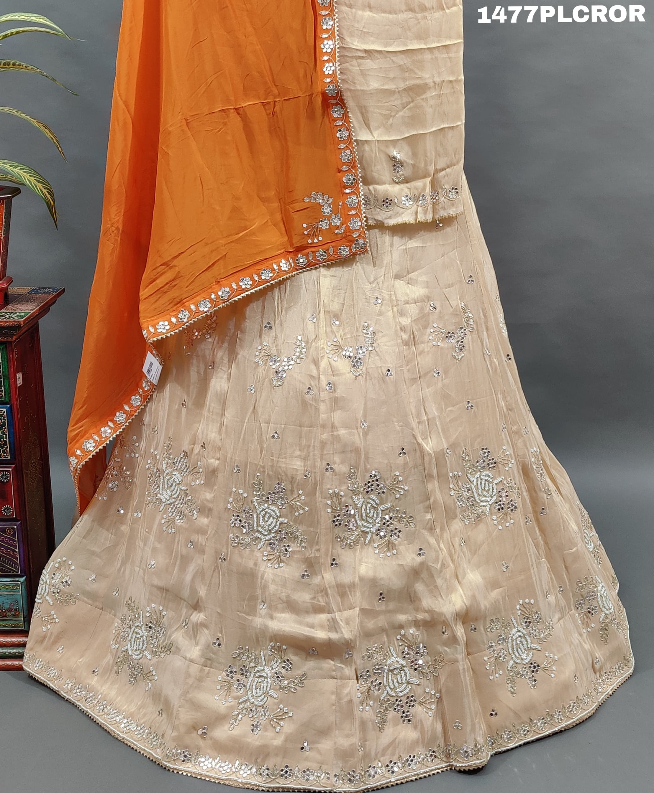 A traditional Indian lehenga with beige and orange colors.