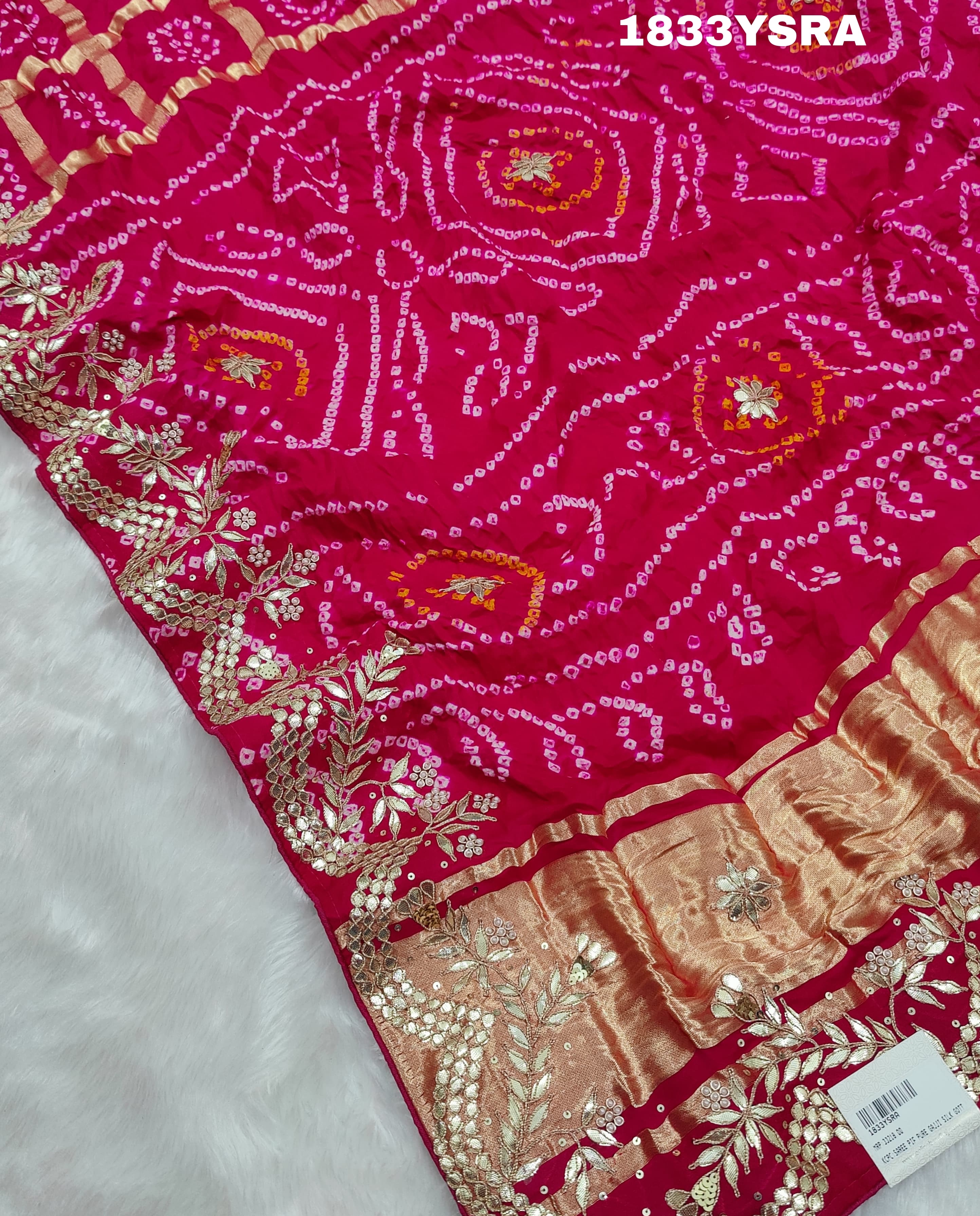 A pink saree with detailed golden and silver gotapatti work and a floral design