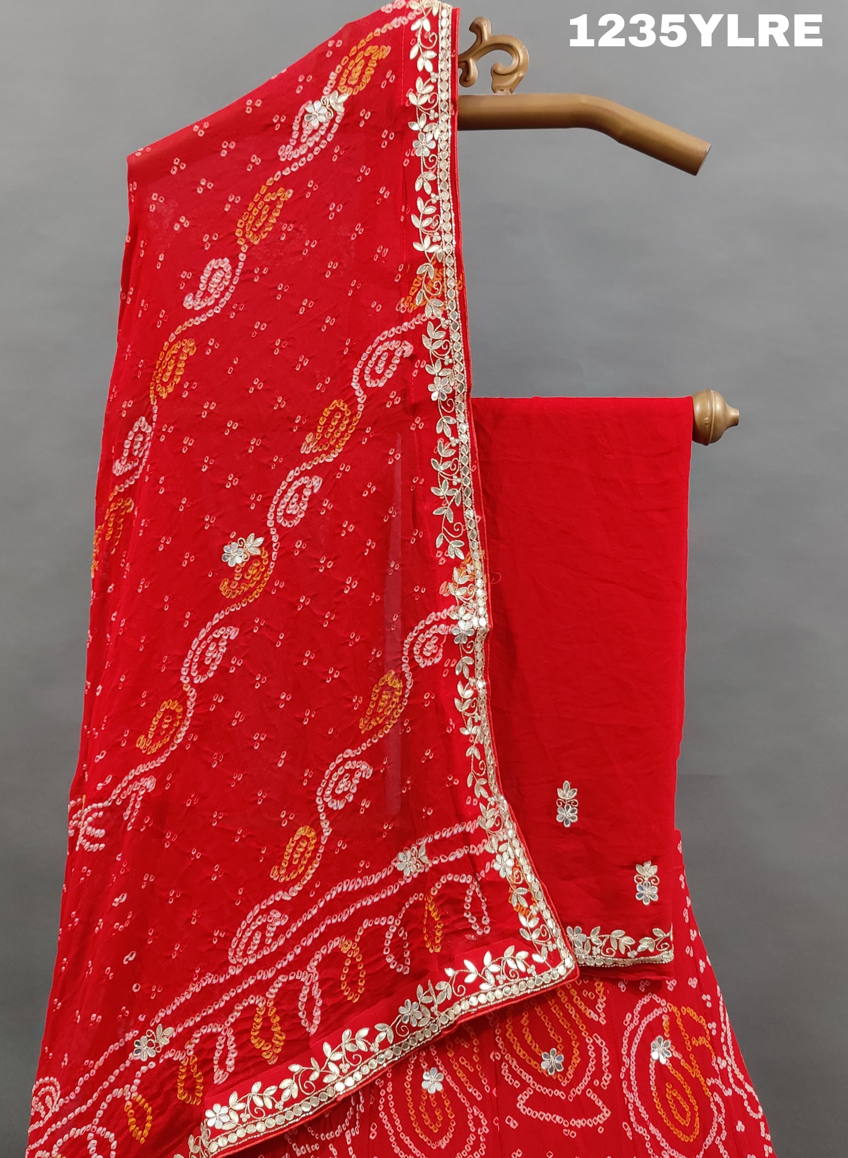 A red lehenga set with gota patti work