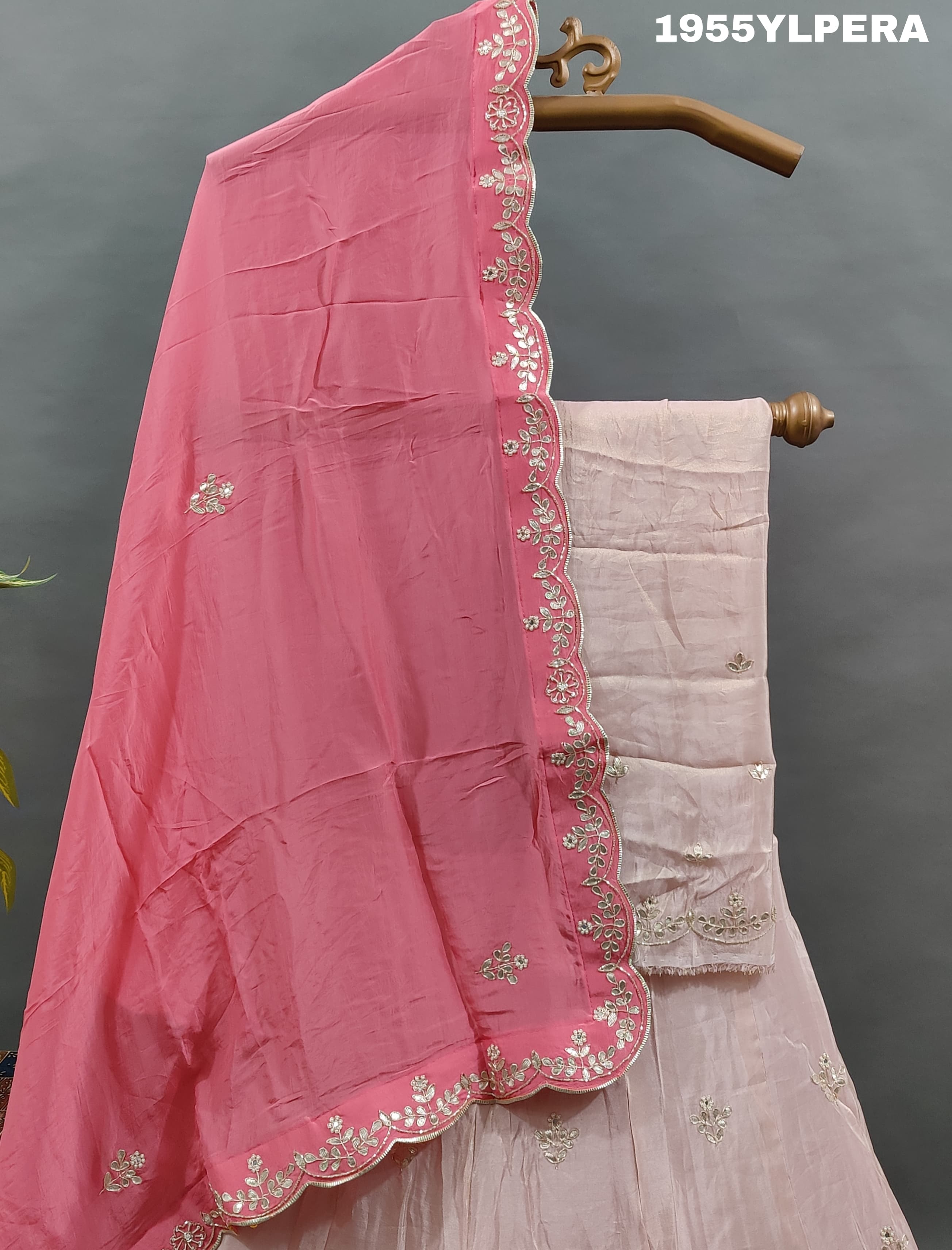 A pink silk lehenga set with gota work