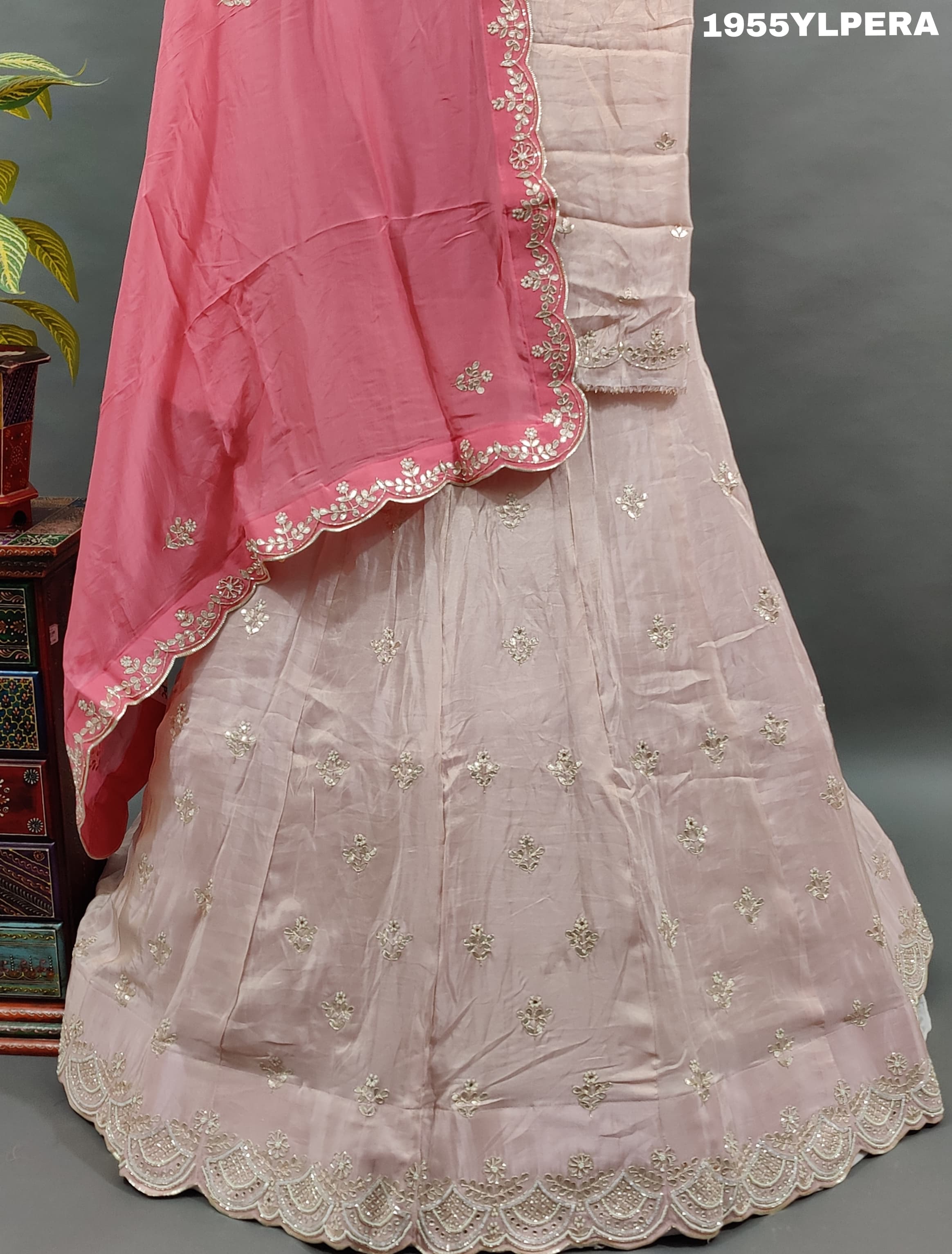 A pink silk lehenga set with gota work