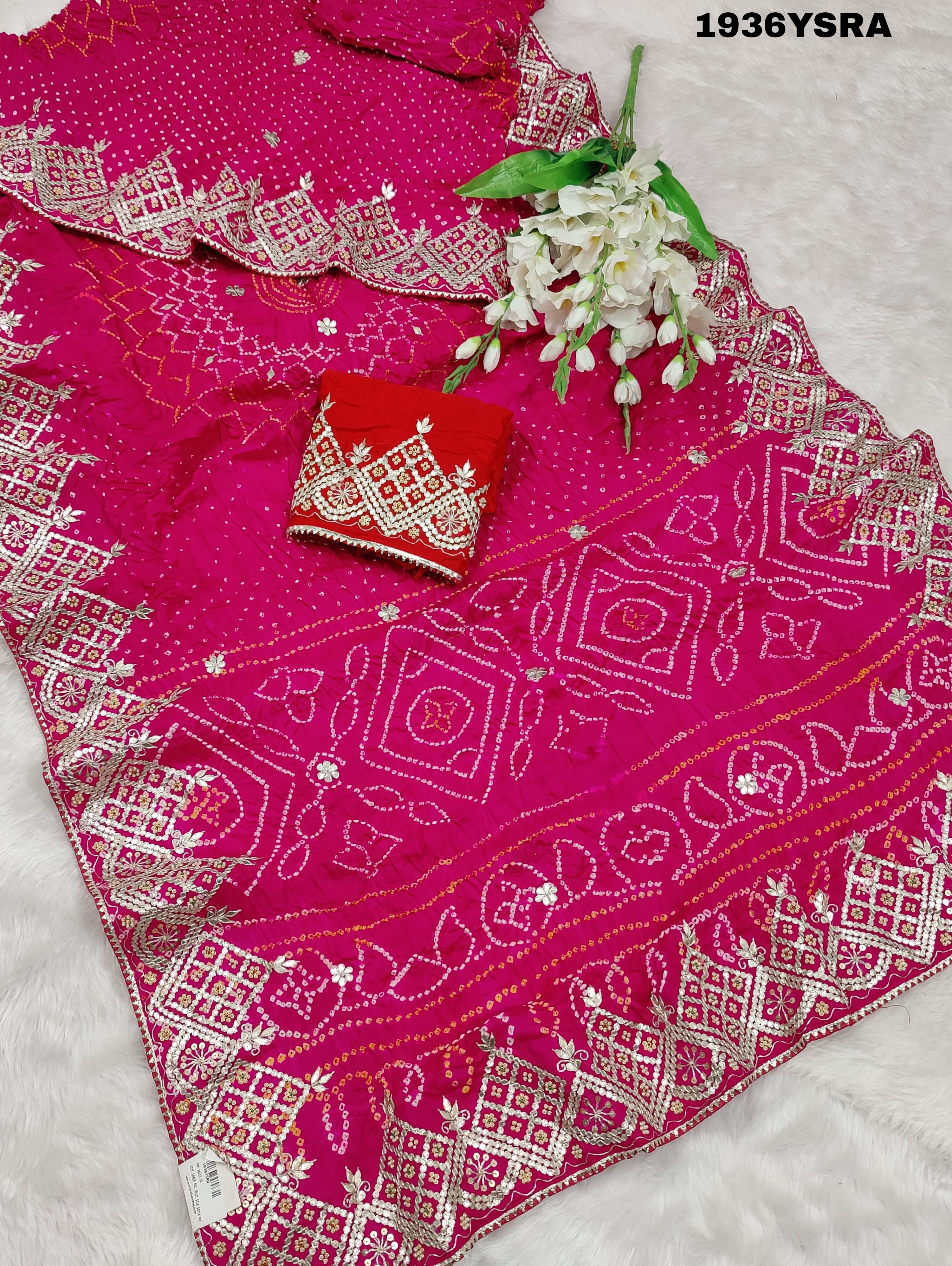 A pink saree with Bandhej pattern and Gotapatti work