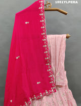A pink traditional lehenga set with white beadwork and a red dupatta