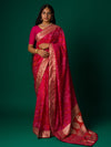 A pink and orange bandhani saree with a zari border