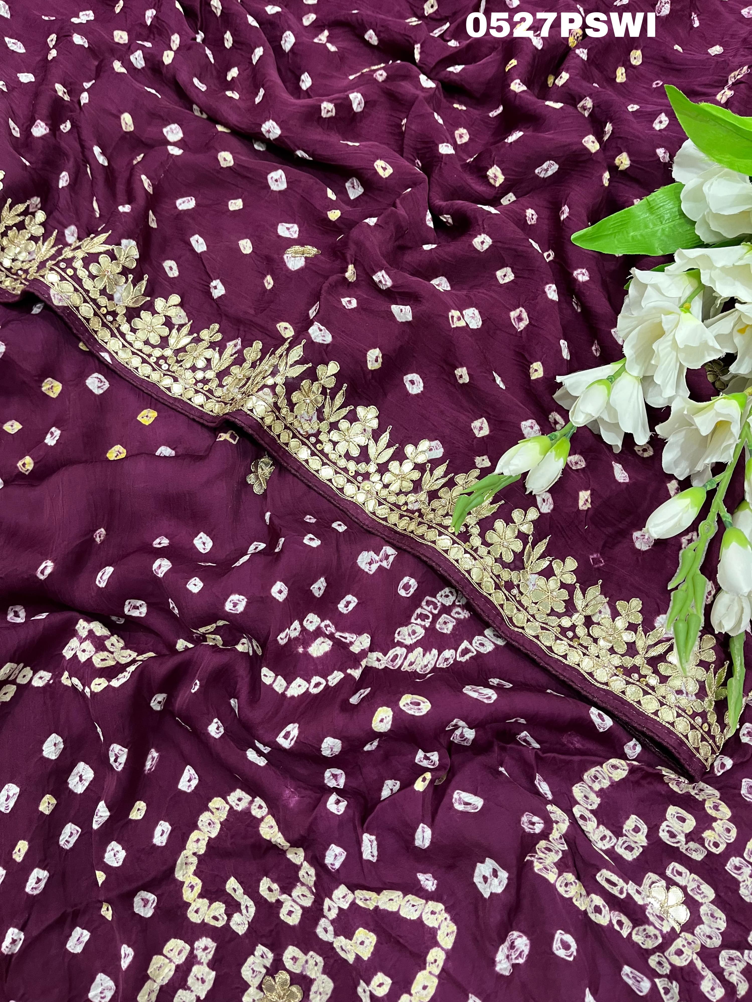 A purple modal silk bandhani saree with gota patti work and a floral embellishment