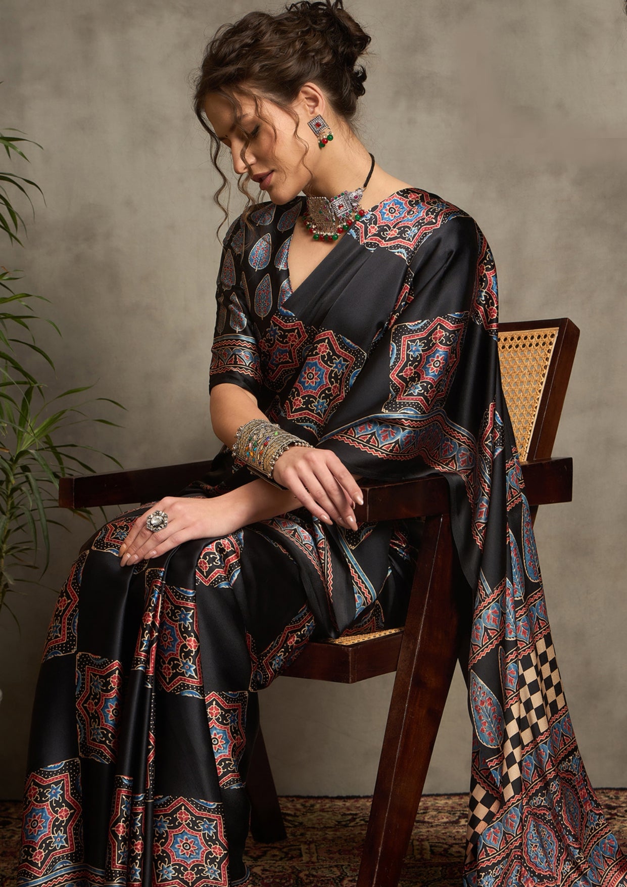 A black saree with red and blue floral ajrak print