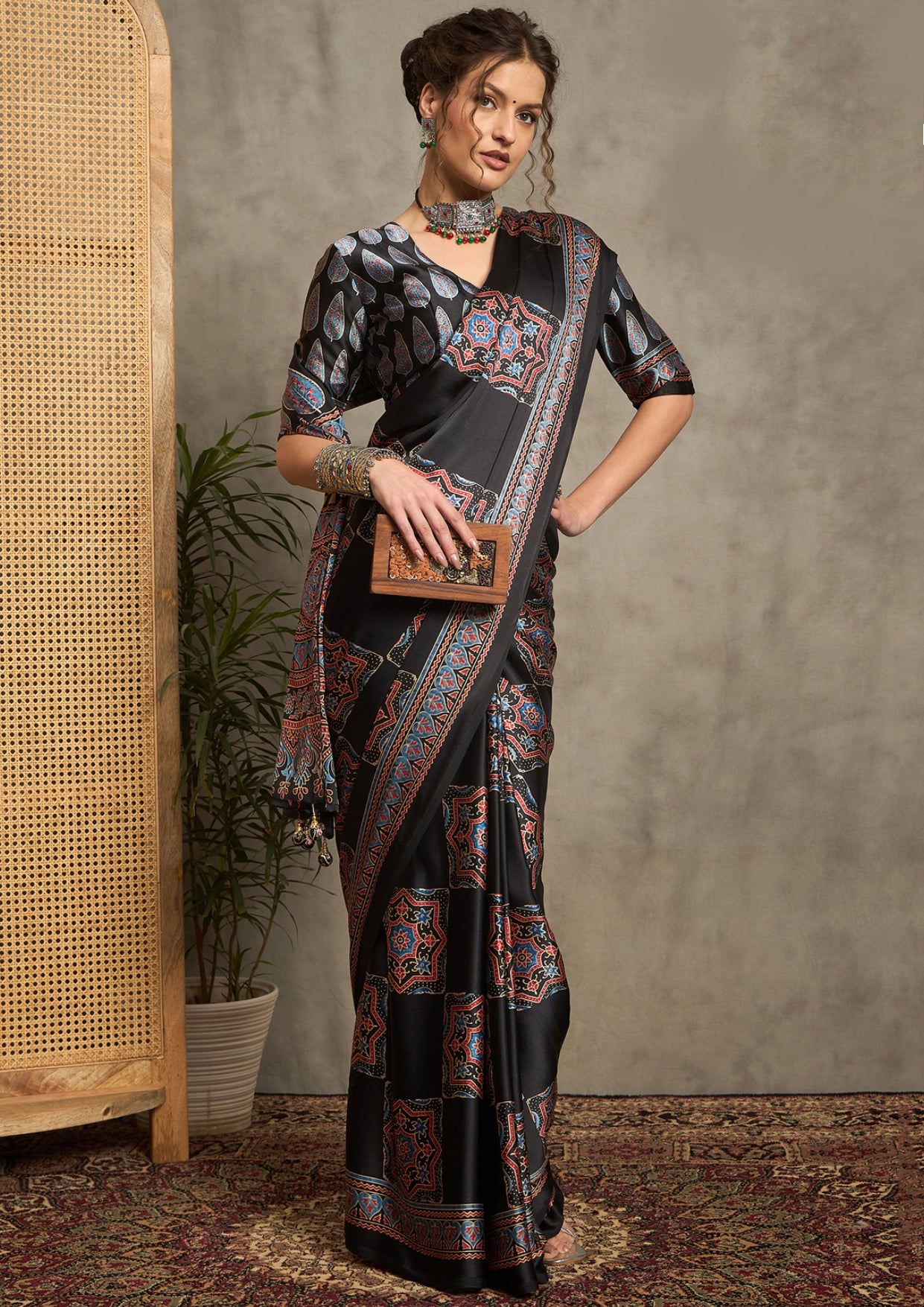 A black saree with red and blue floral ajrak print