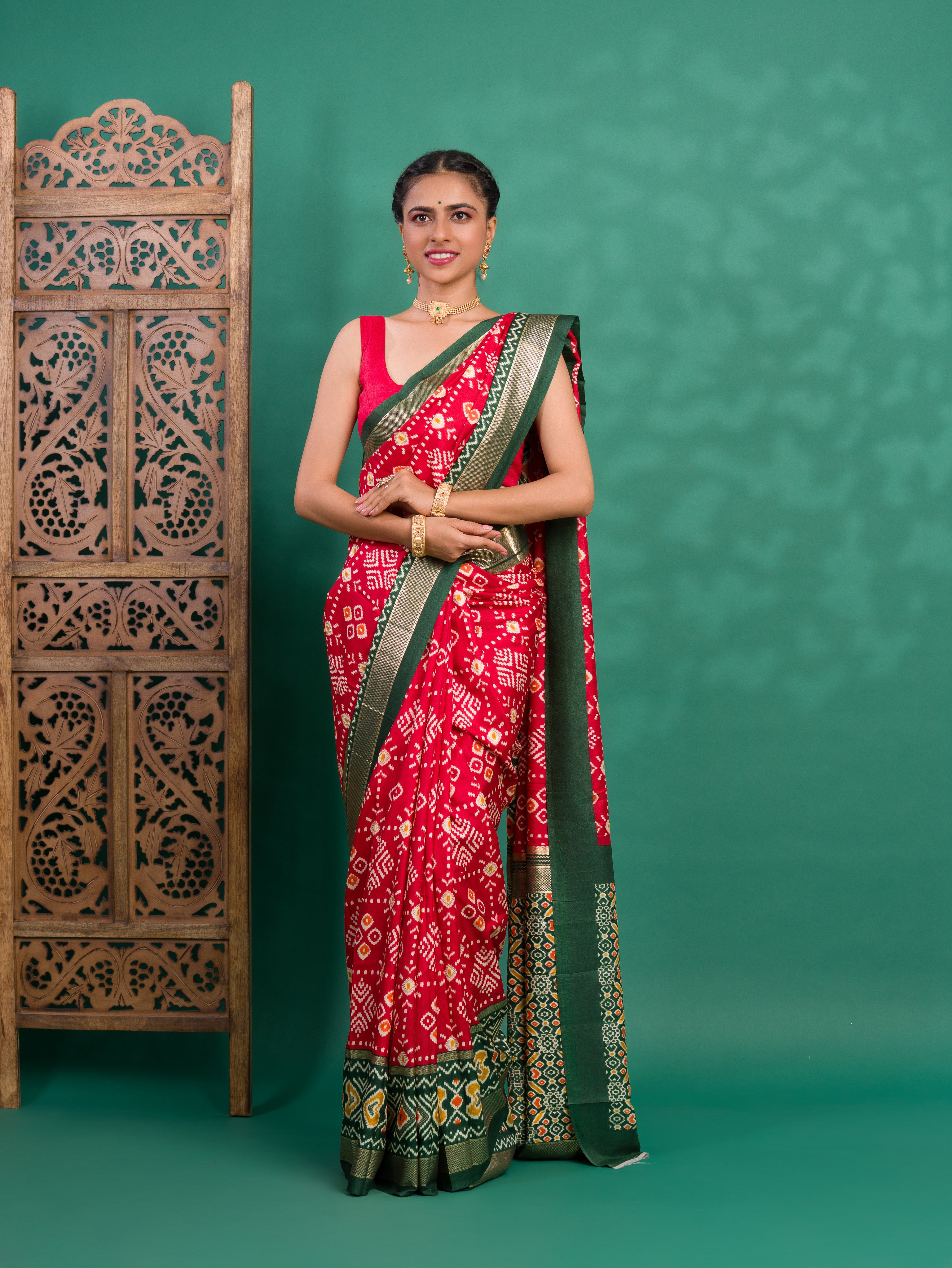 A green and red pashmina cotton silk saree with a patola style pattern