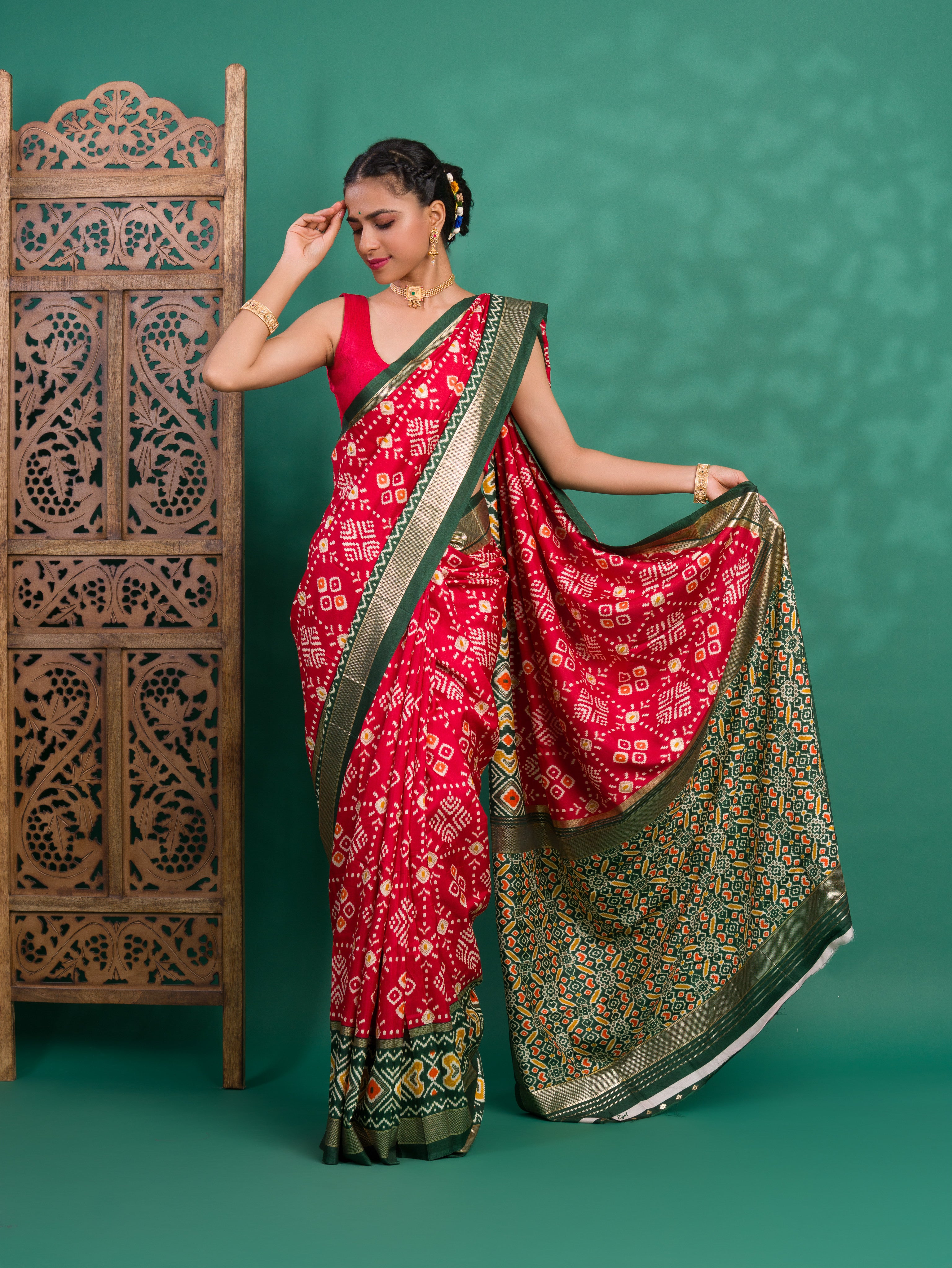 A green and red pashmina cotton silk saree with a patola style pattern