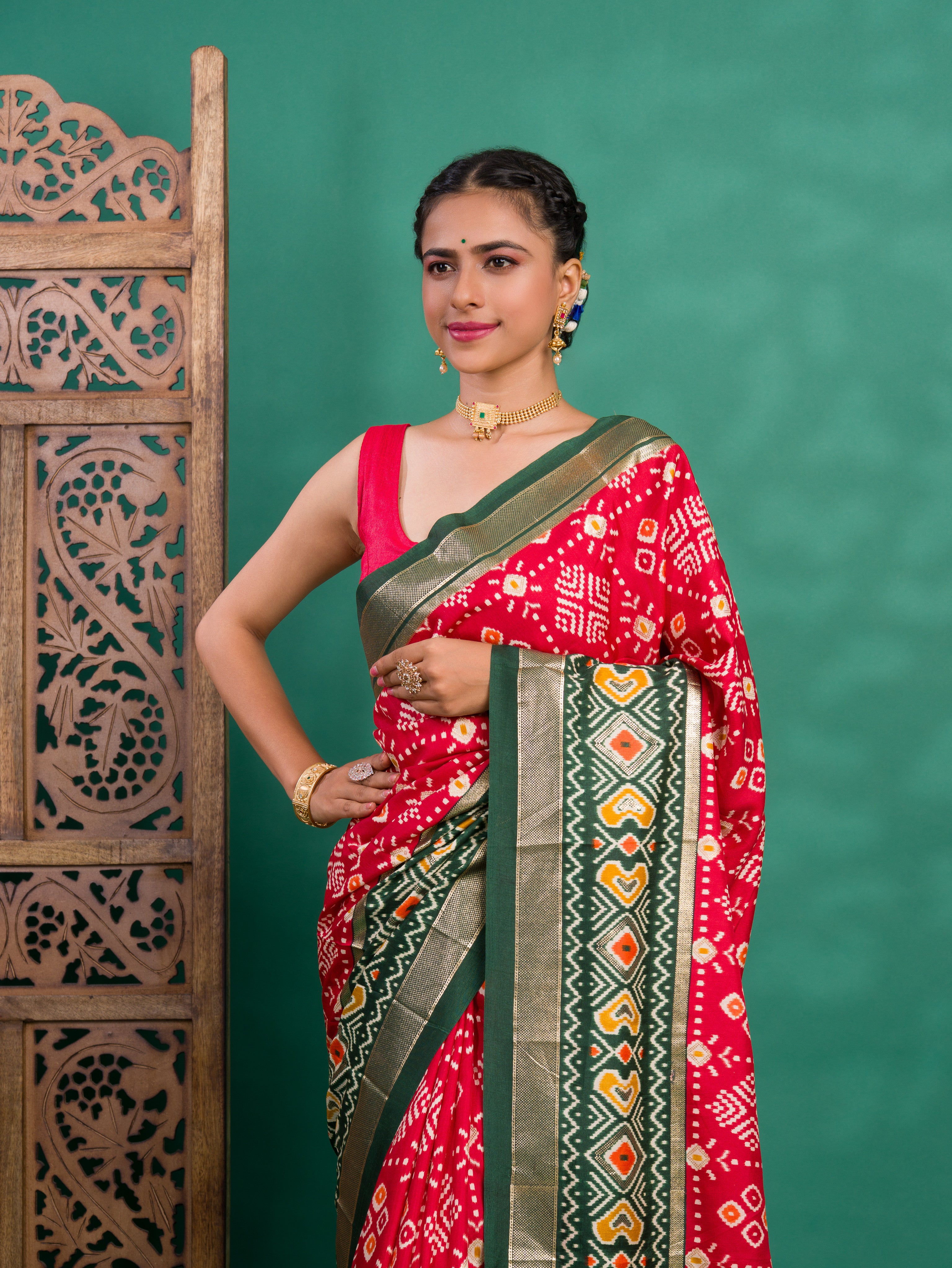 A green and red pashmina cotton silk saree with a patola style pattern