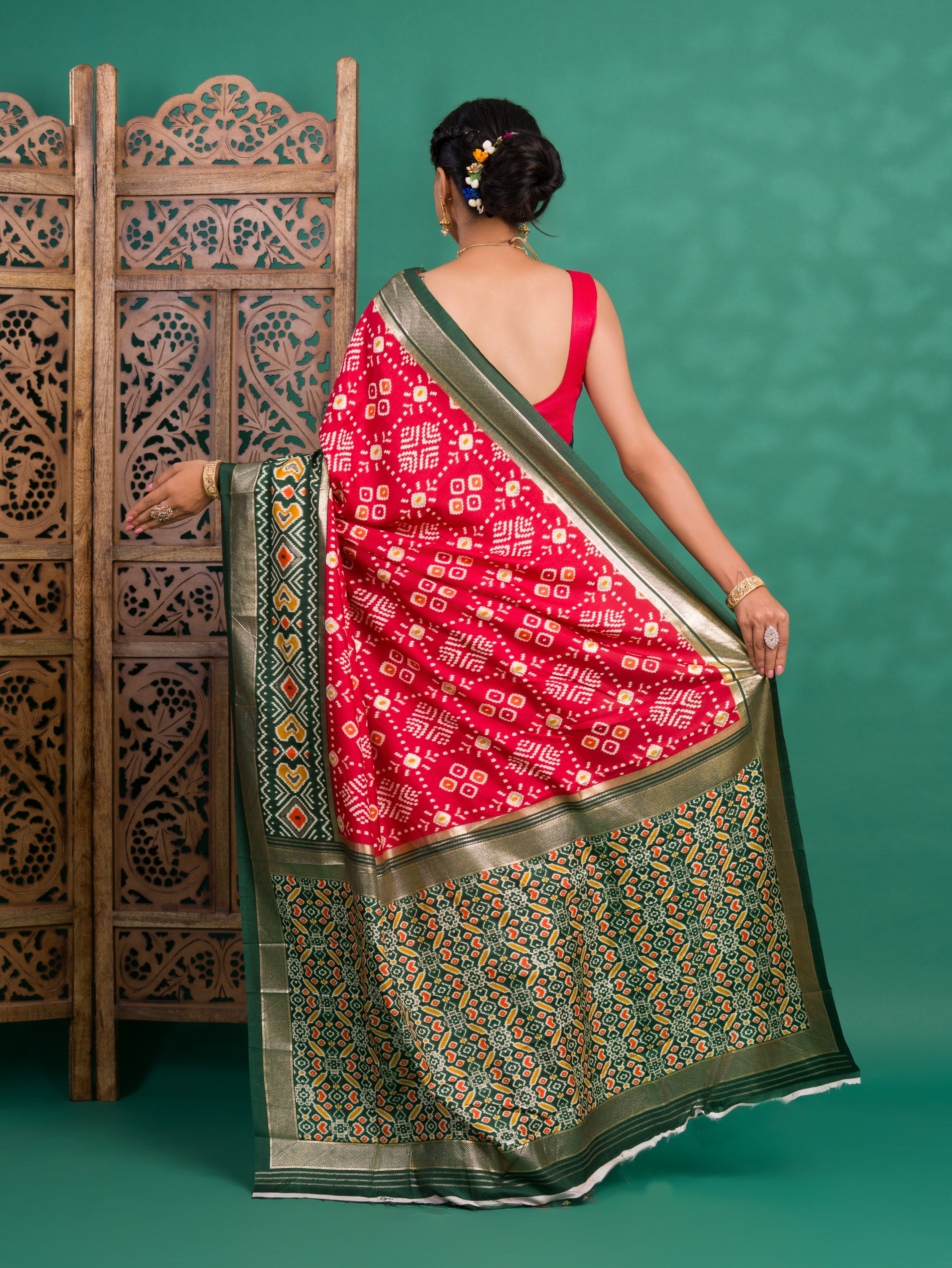 A green and red pashmina cotton silk saree with a patola style pattern