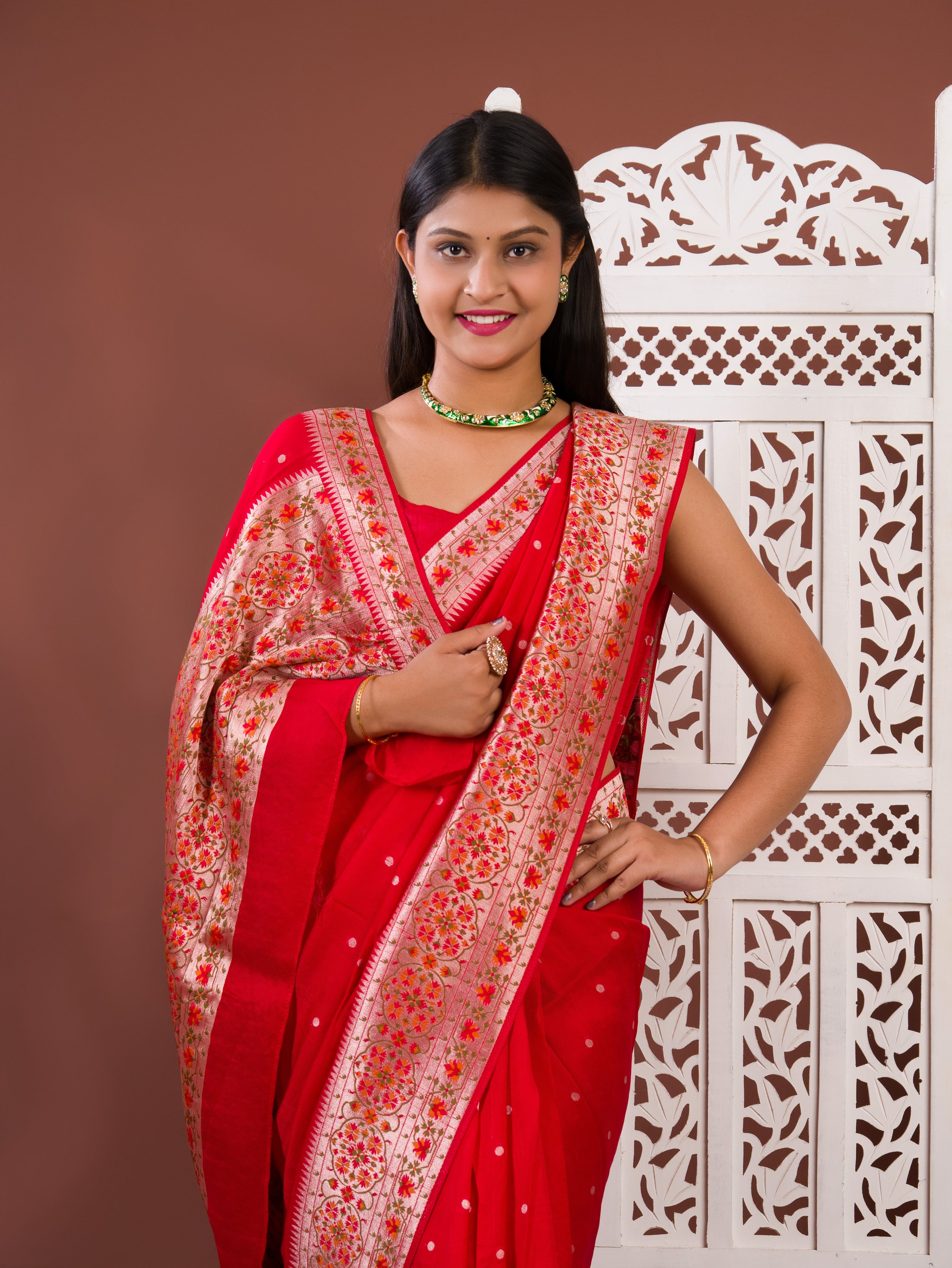 A red saree with white patternsBanarasi Zari Weaving Saree