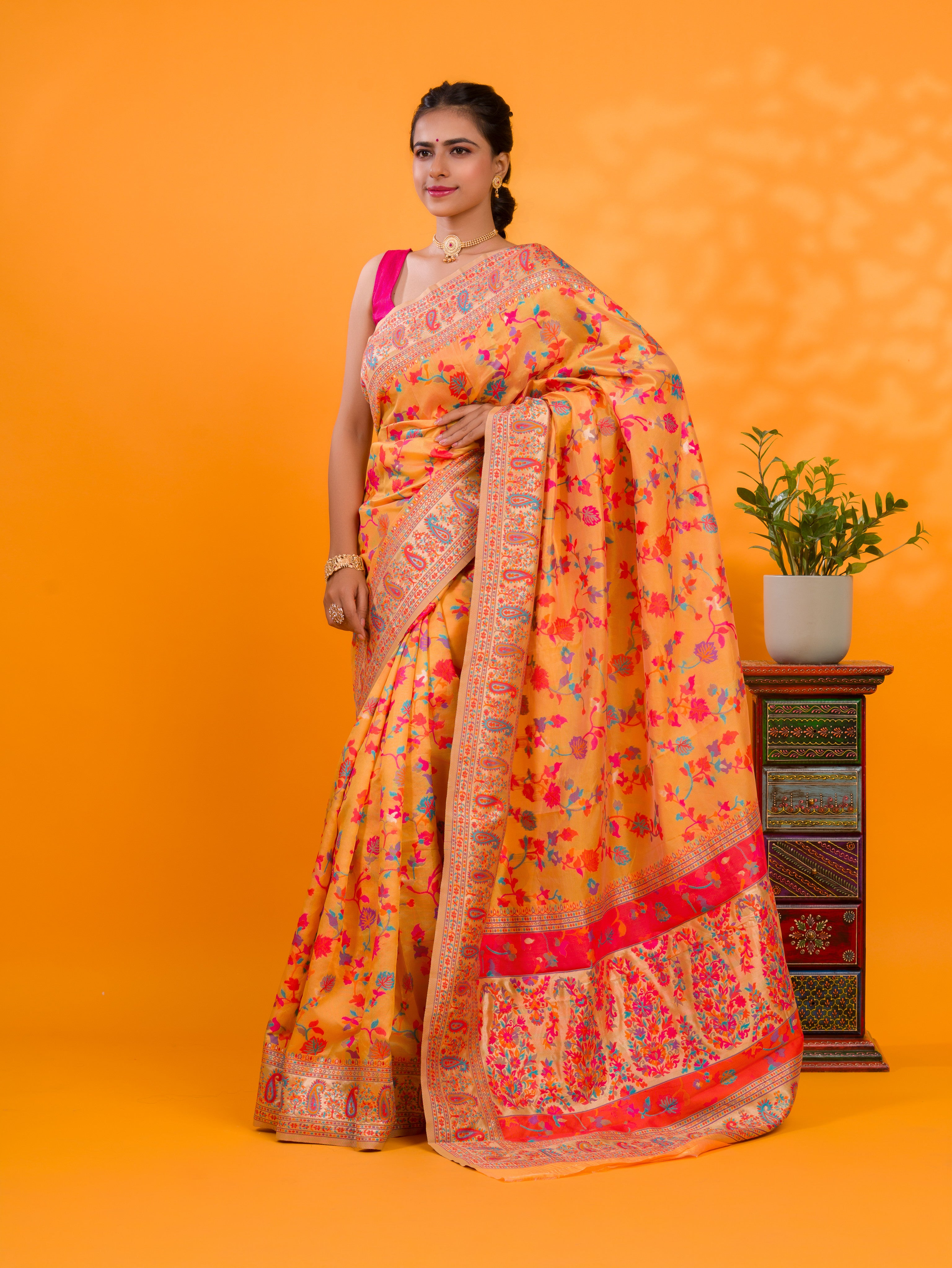 A yellow cotton silk saree with Kashmiri style patterns and Meenakari weaving work.