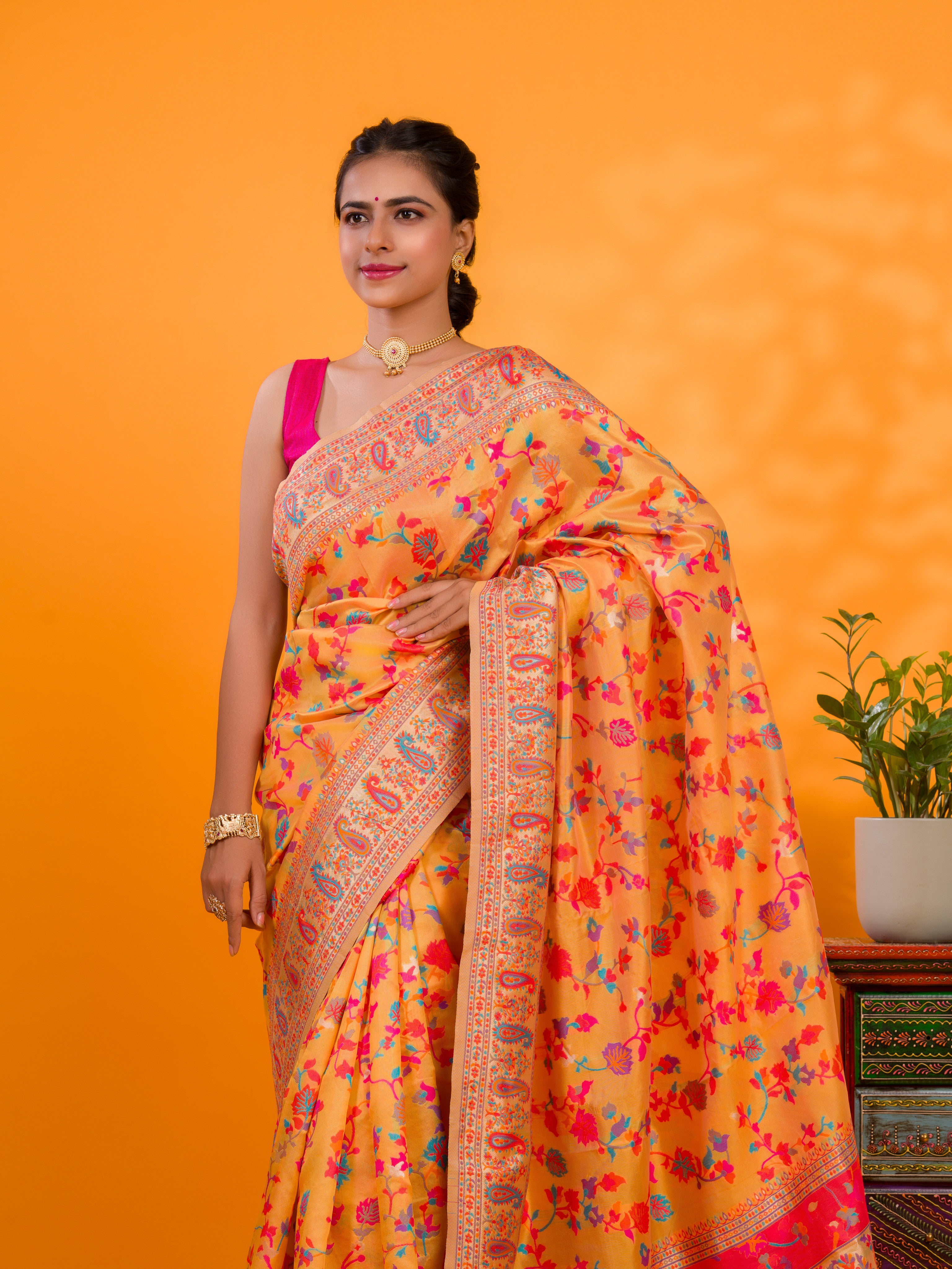 A yellow cotton silk saree with Kashmiri style patterns and Meenakari weaving work.