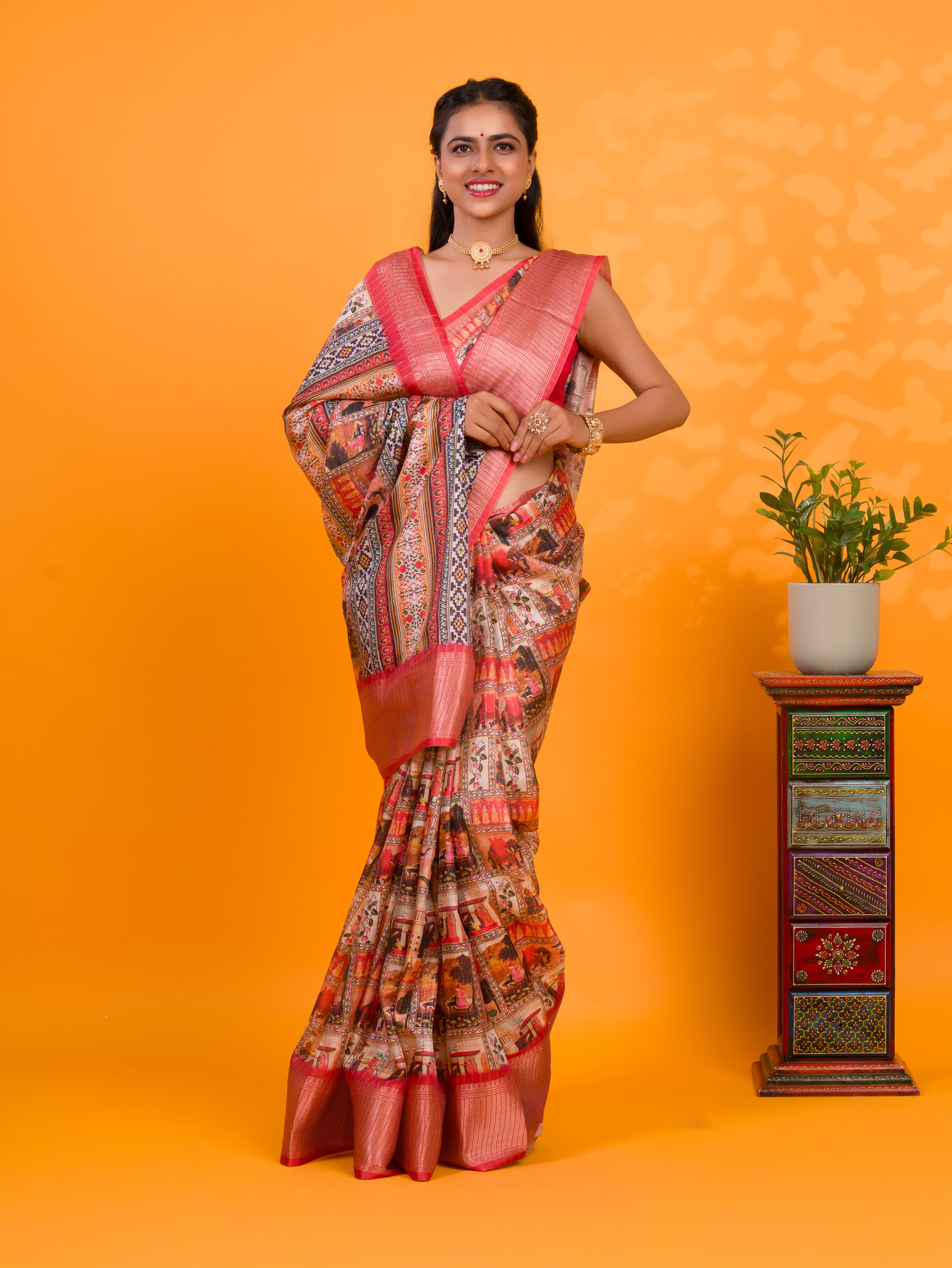 A saree with a kalamkari style pattern in red colors, with zari weaving and a Banarasi border. under 1000