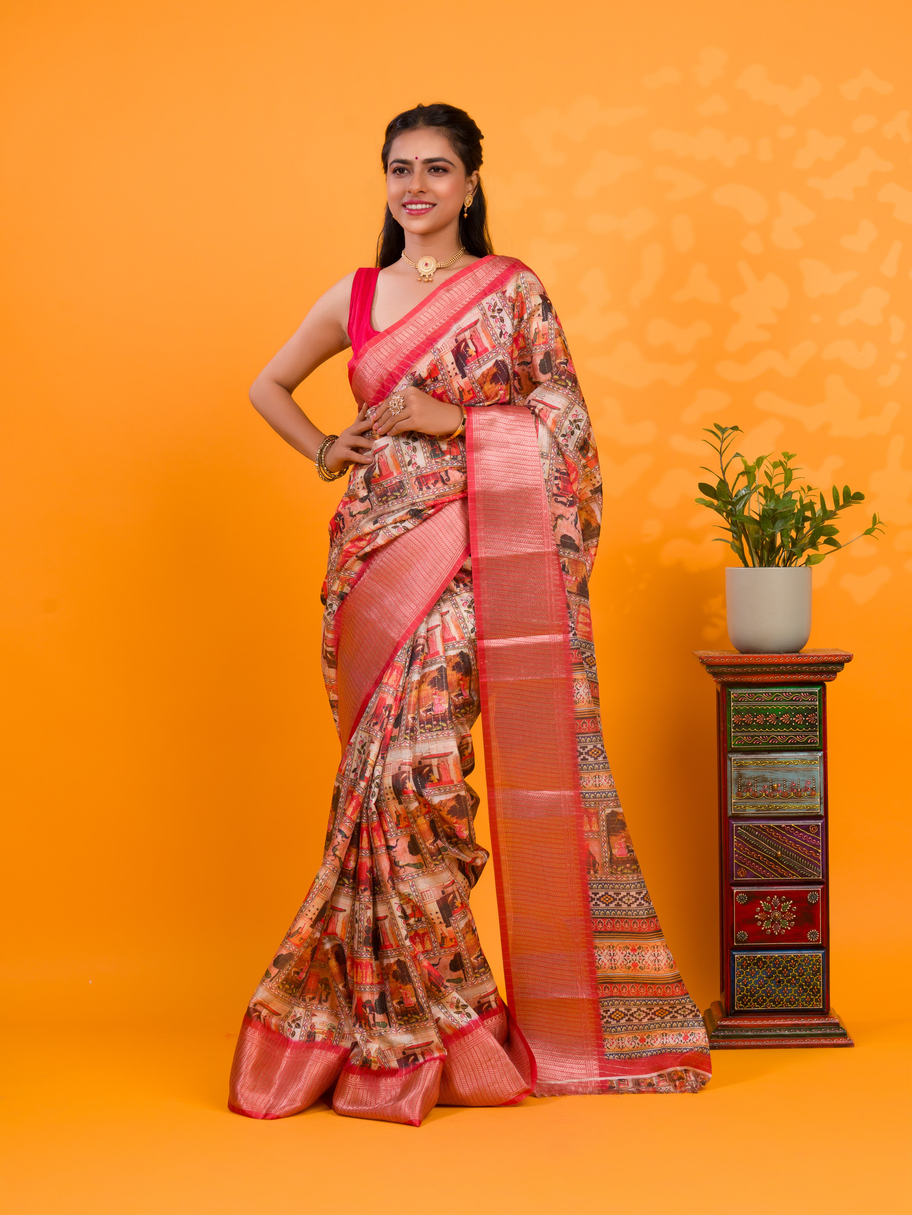 A saree with a kalamkari style pattern in red colors, with zari weaving and a Banarasi border. under 1000