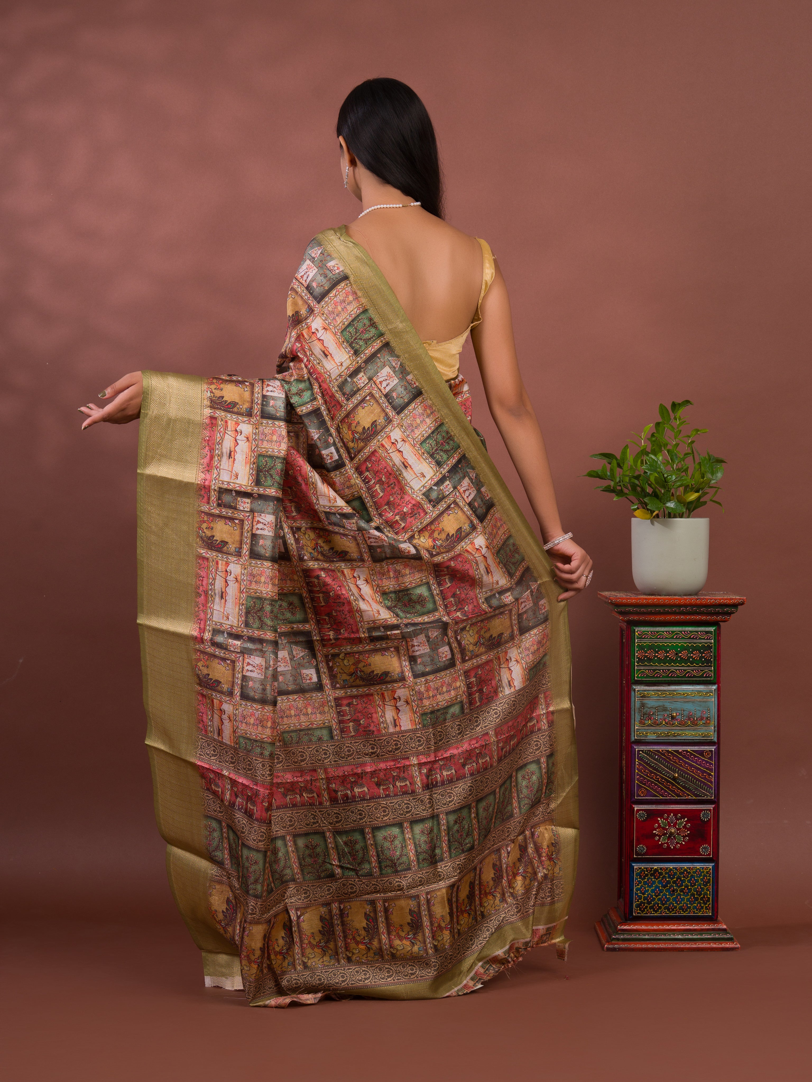 A saree with a kalamkari style pattern in green colors, with zari weaving and a Banarasi border. under 1000