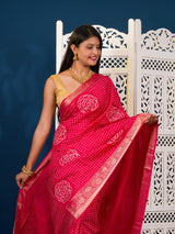 A pink and gold Upada silk saree with Bandhani style embellishments and Zari work,