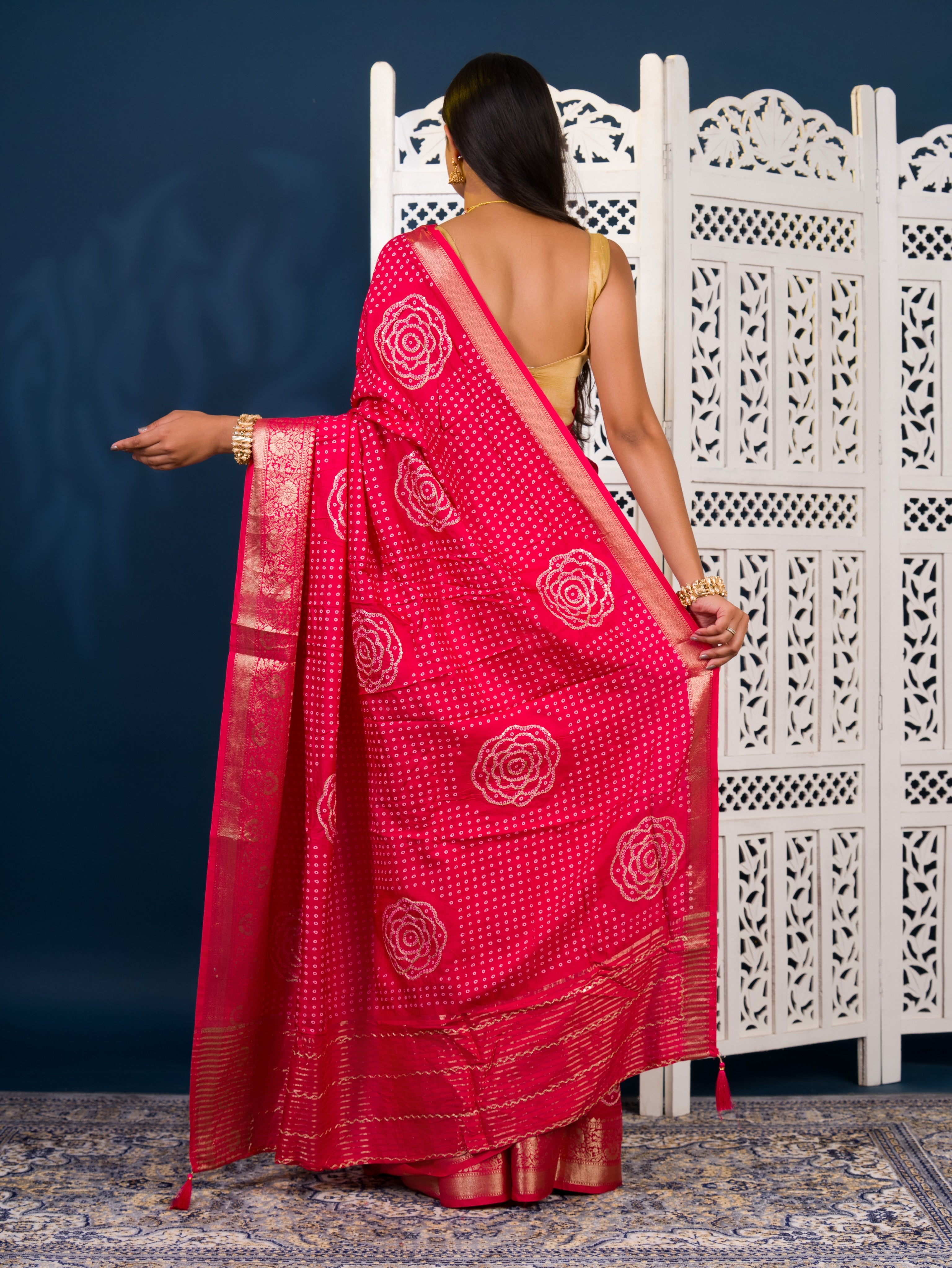 A pink and gold Upada silk saree with Bandhani style embellishments and Zari work,
