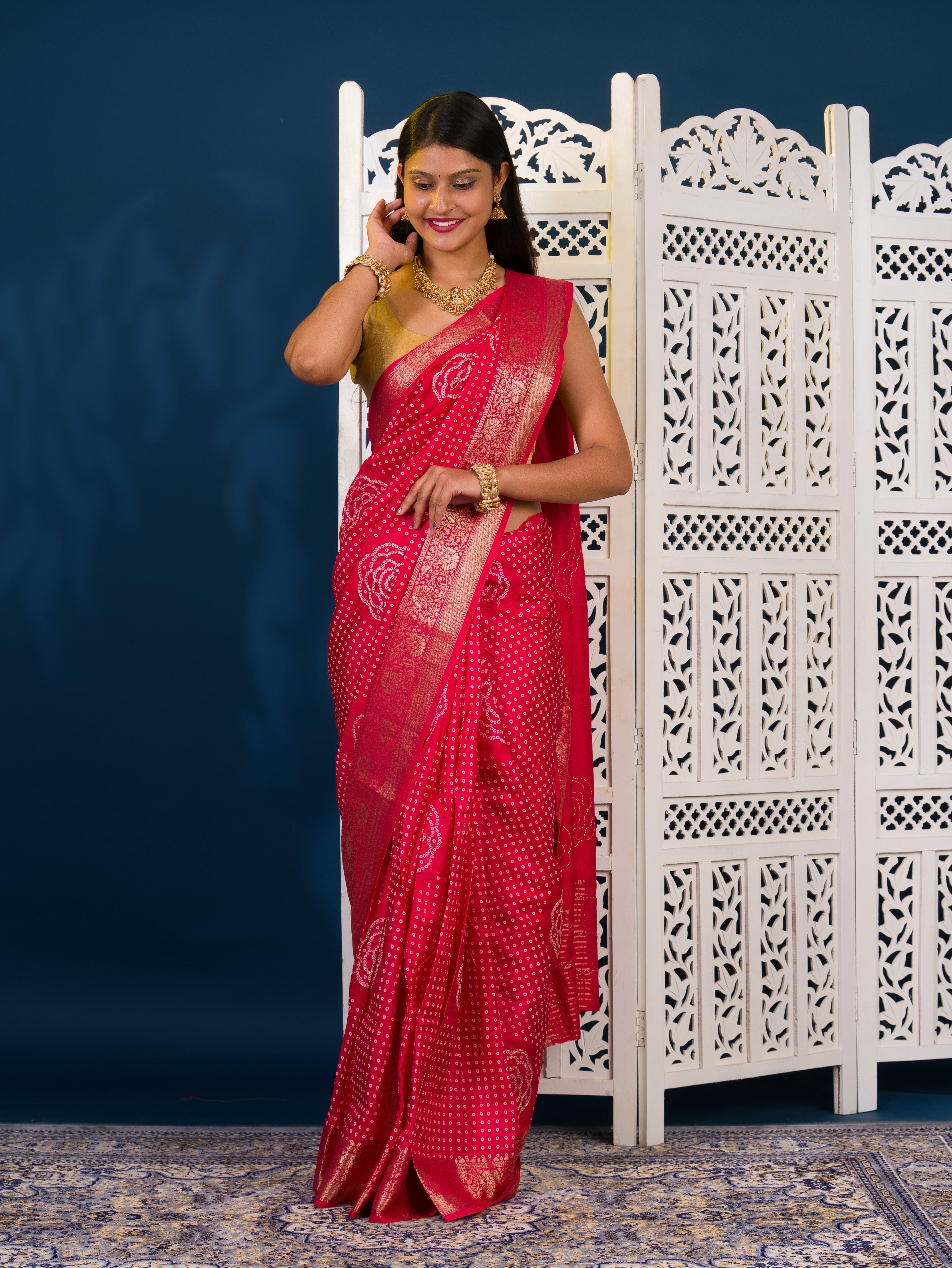 A pink and gold Upada silk saree with Bandhani style embellishments and Zari work,