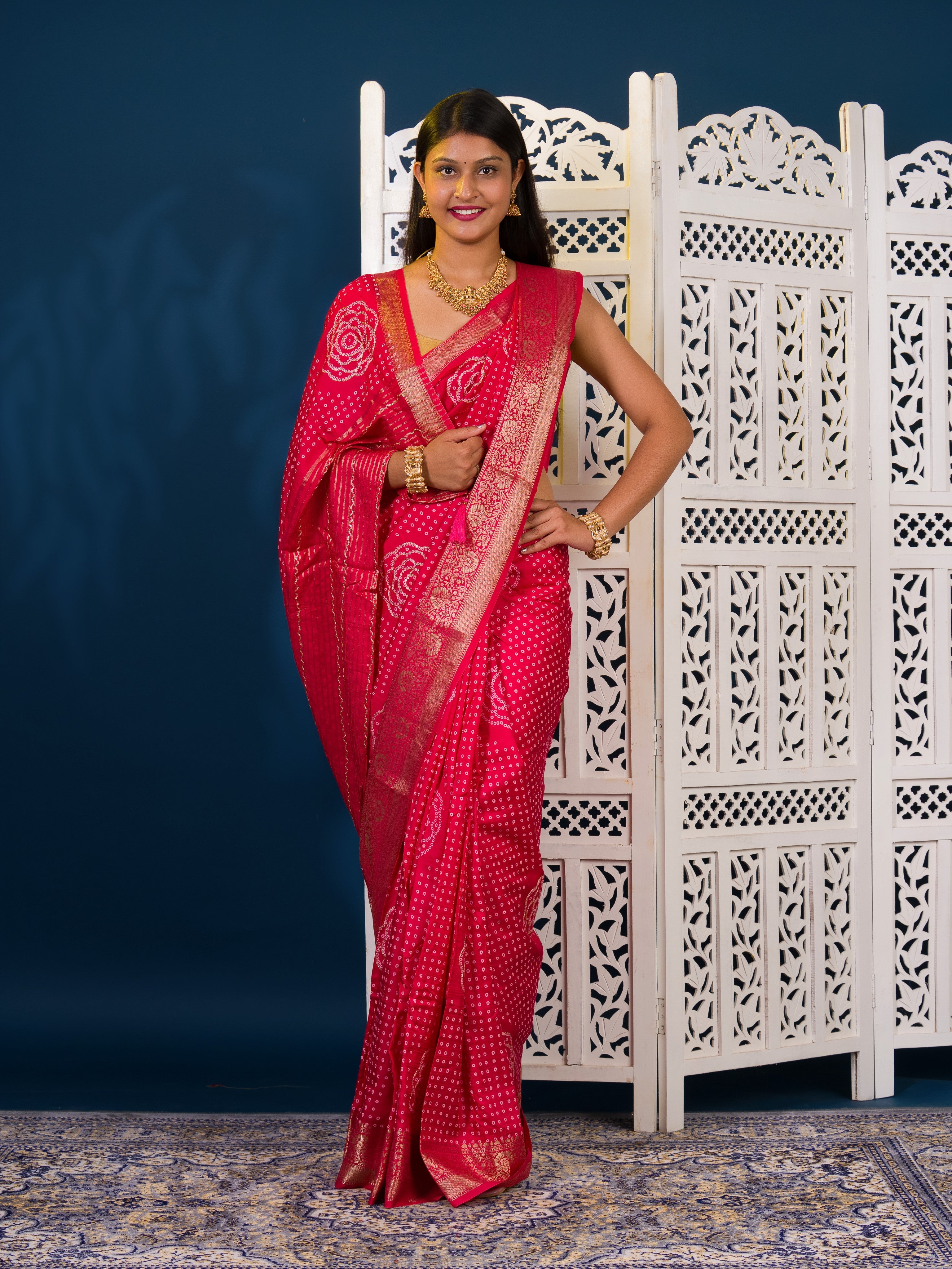 A pink and gold Upada silk saree with Bandhani style embellishments and Zari work,