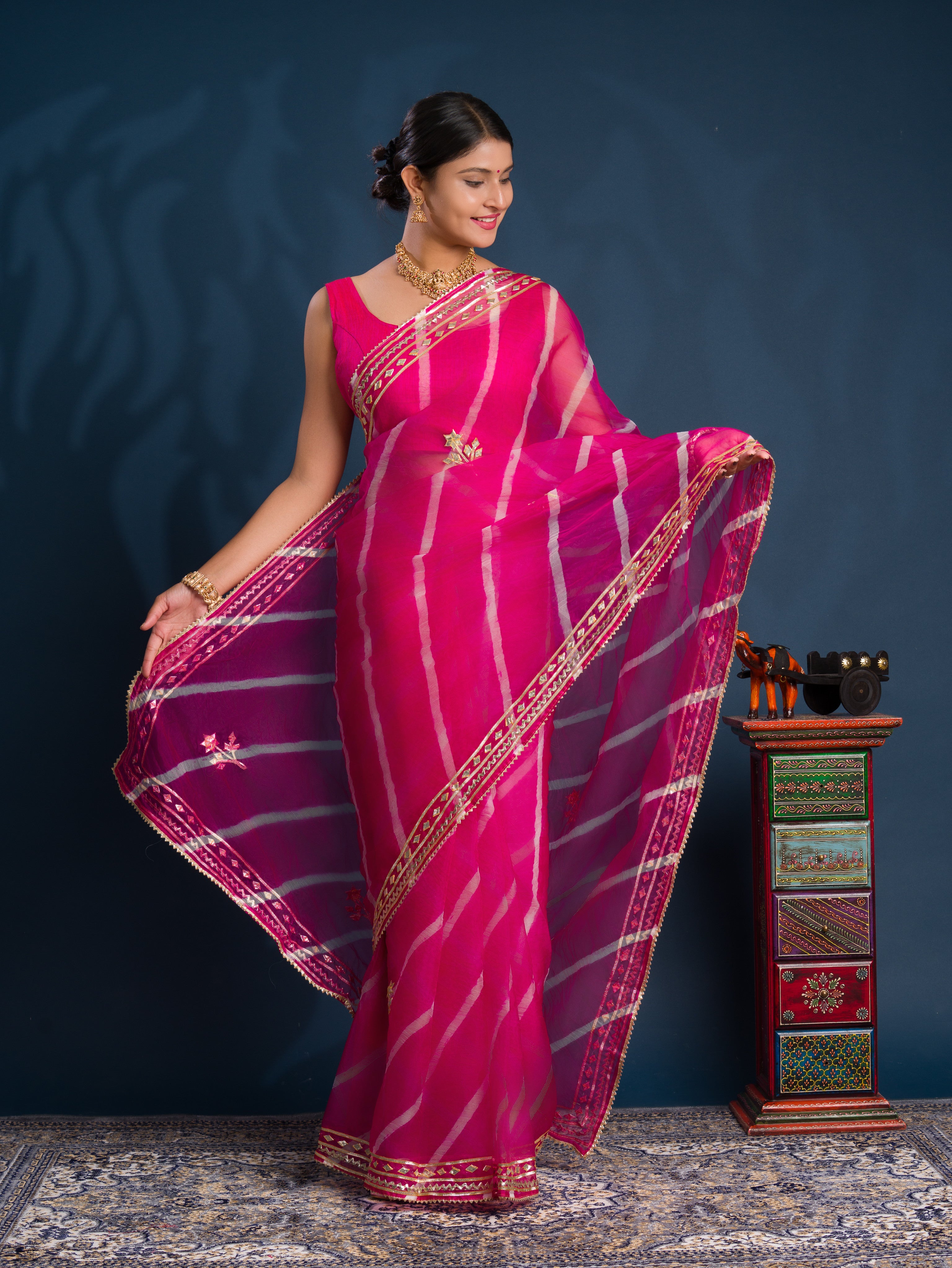 Pink saree with gold patternsOrganza Leheriya Style With Gotapatti Work