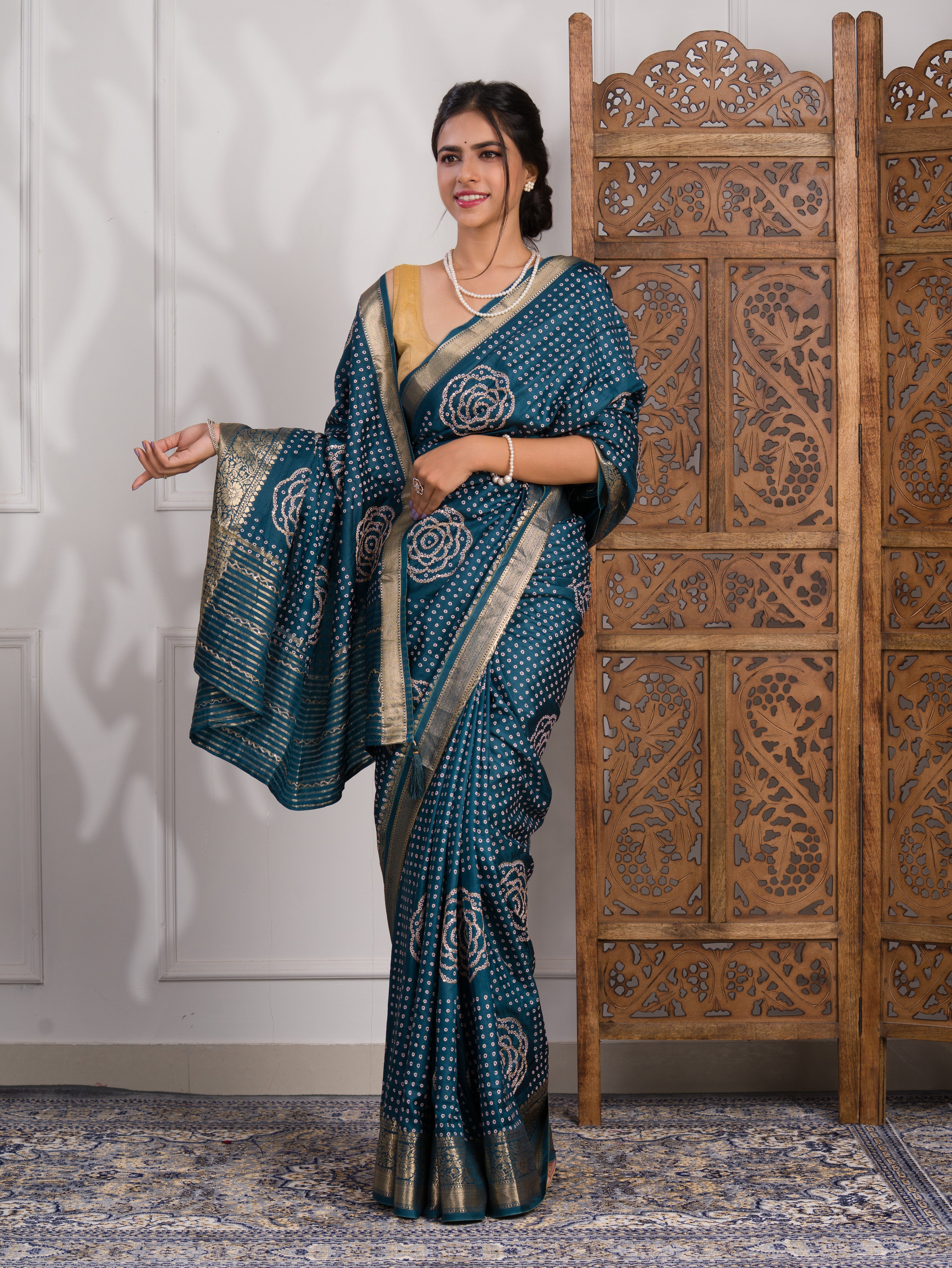 A blue saree with bandhani style embellishments and zari work