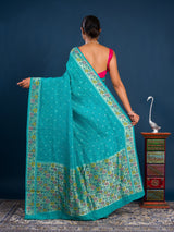 A teal saree with floral patternsBanarasi Silk Printed Style With zari weaving Work Saree