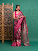 A saree with a kalamkari style pattern in pink colors, with zari weaving and a Banarasi border.