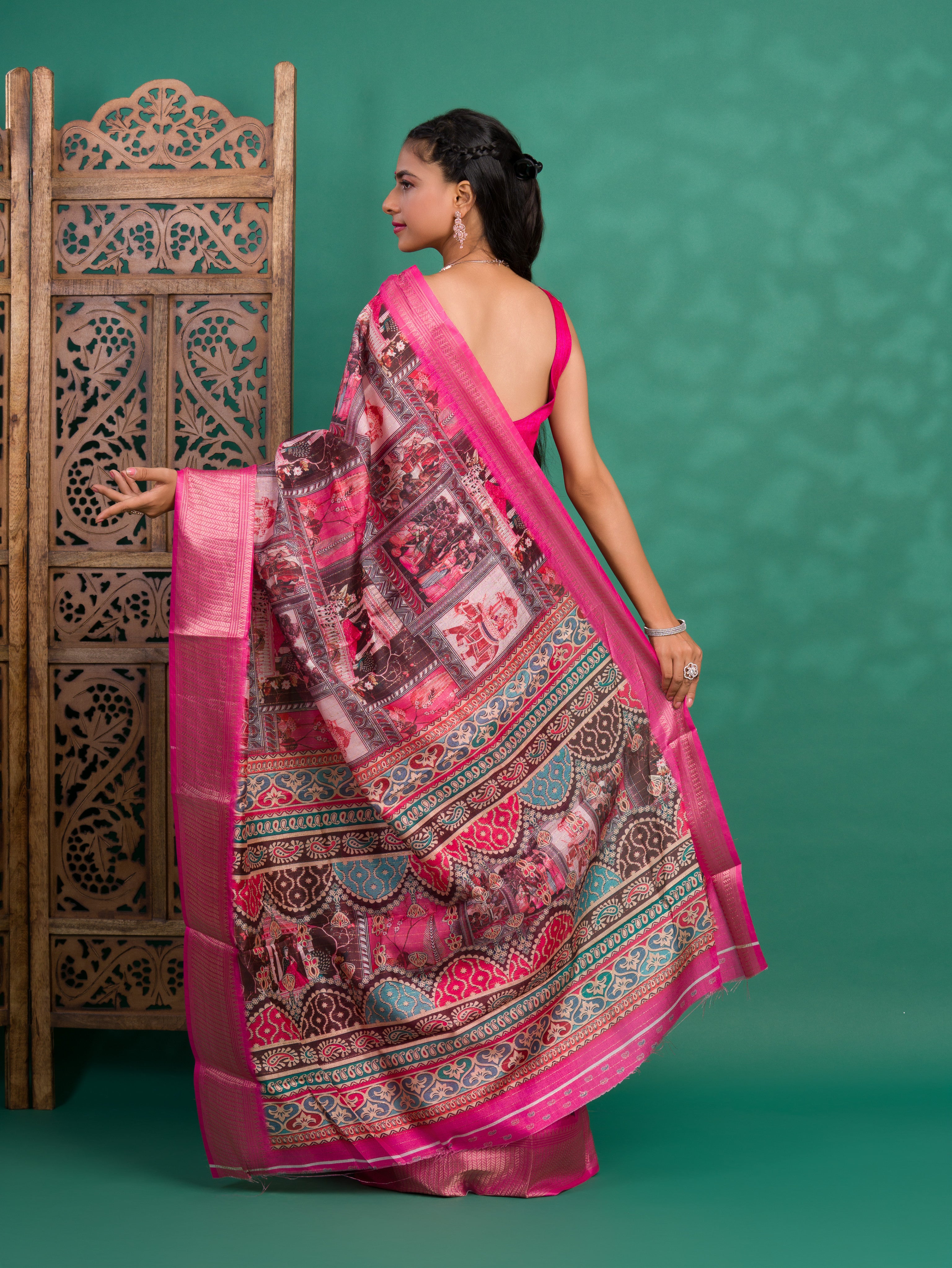 A saree with a kalamkari style pattern in pink colors, with zari weaving and a Banarasi border.