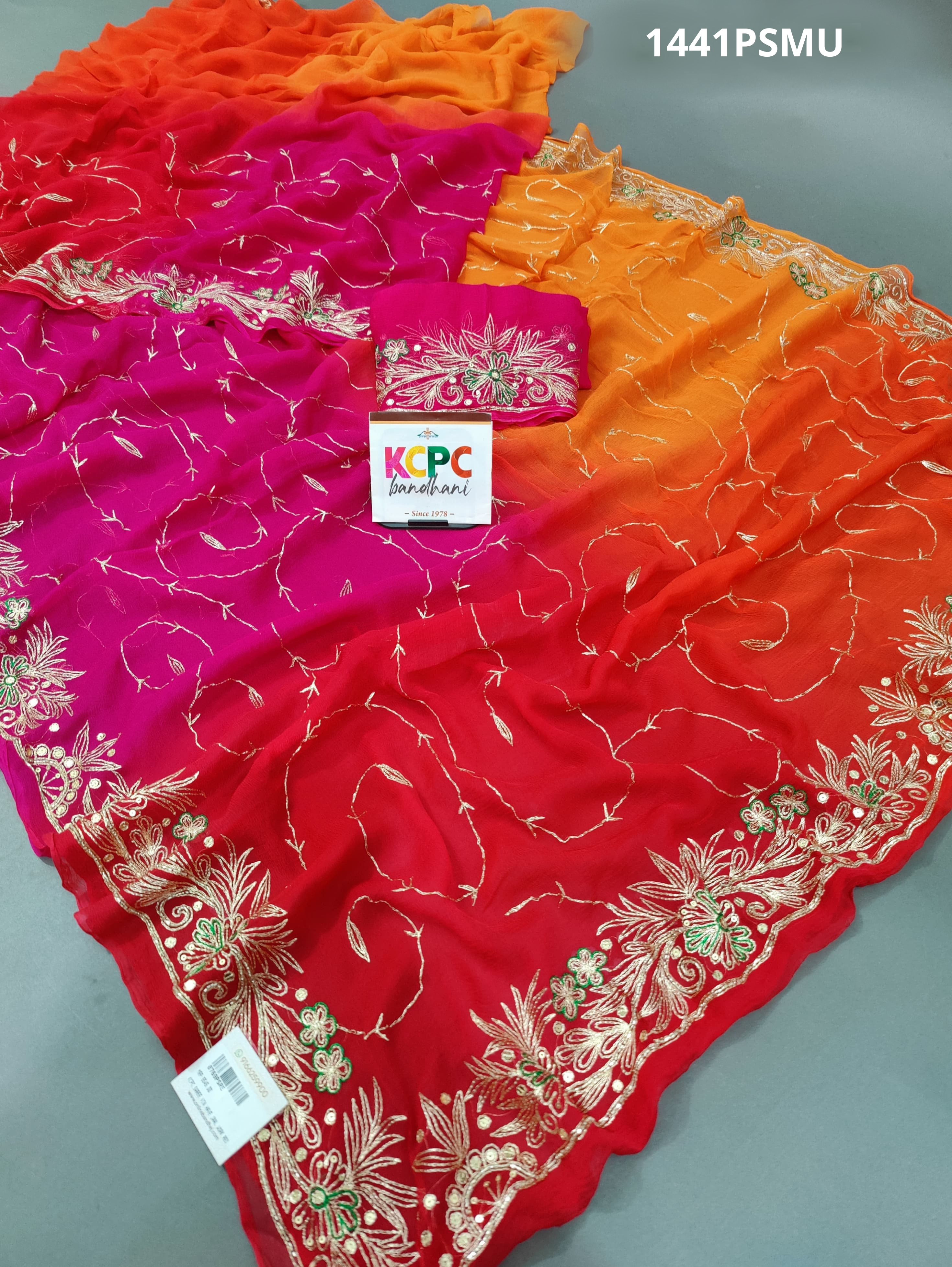 A pink, orange, and gold chiffon saree with Mukesh work