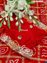 A red Gaji silk Bandhani saree Gota patti work
