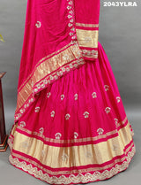 A pink Gaji silk lehenga with floral patterns and gold embellishments