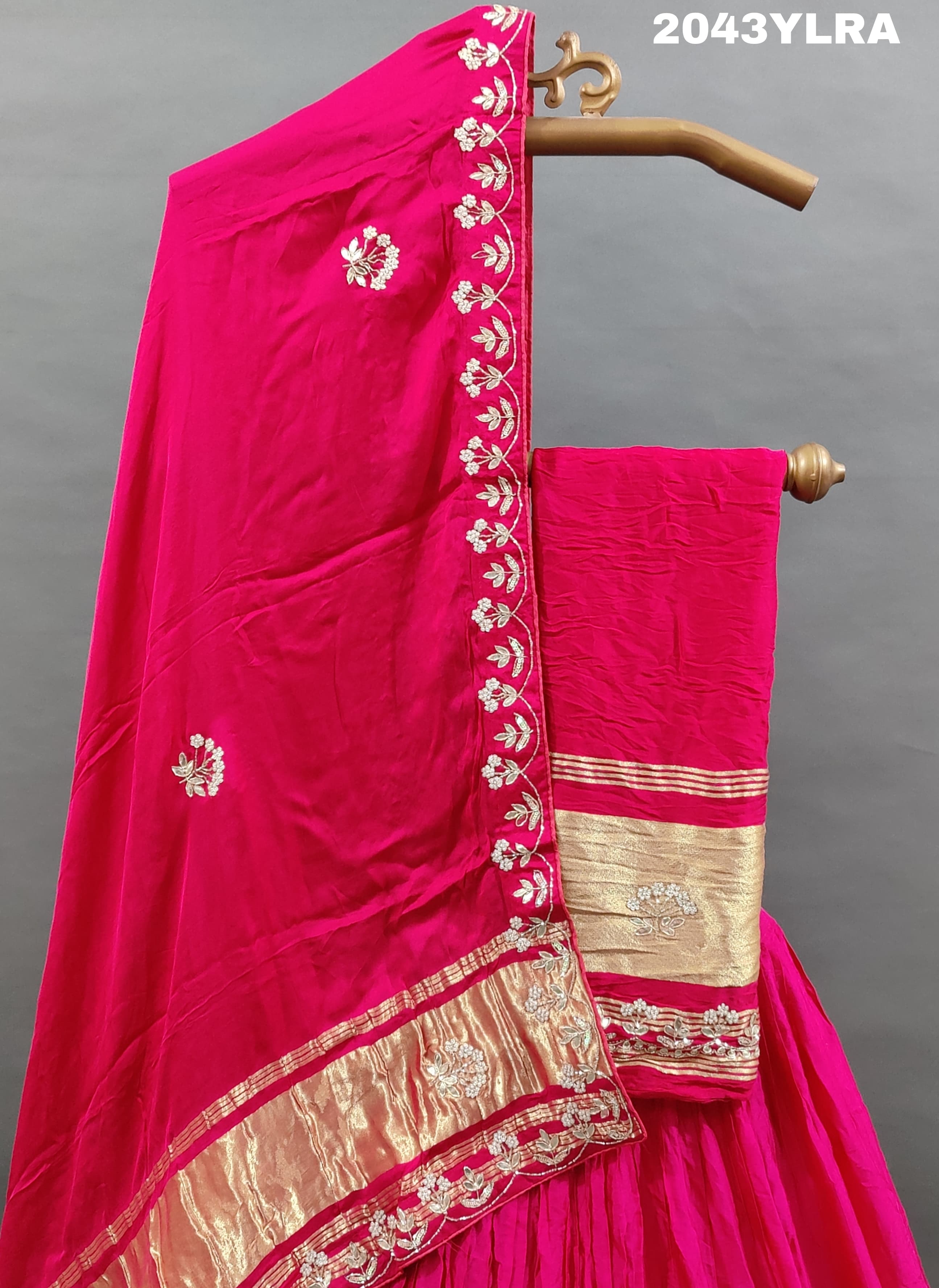 A pink Gaji silk lehenga with floral patterns and gold embellishments