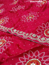 A red and pink silk saree with bandhani style dots and gota patti work