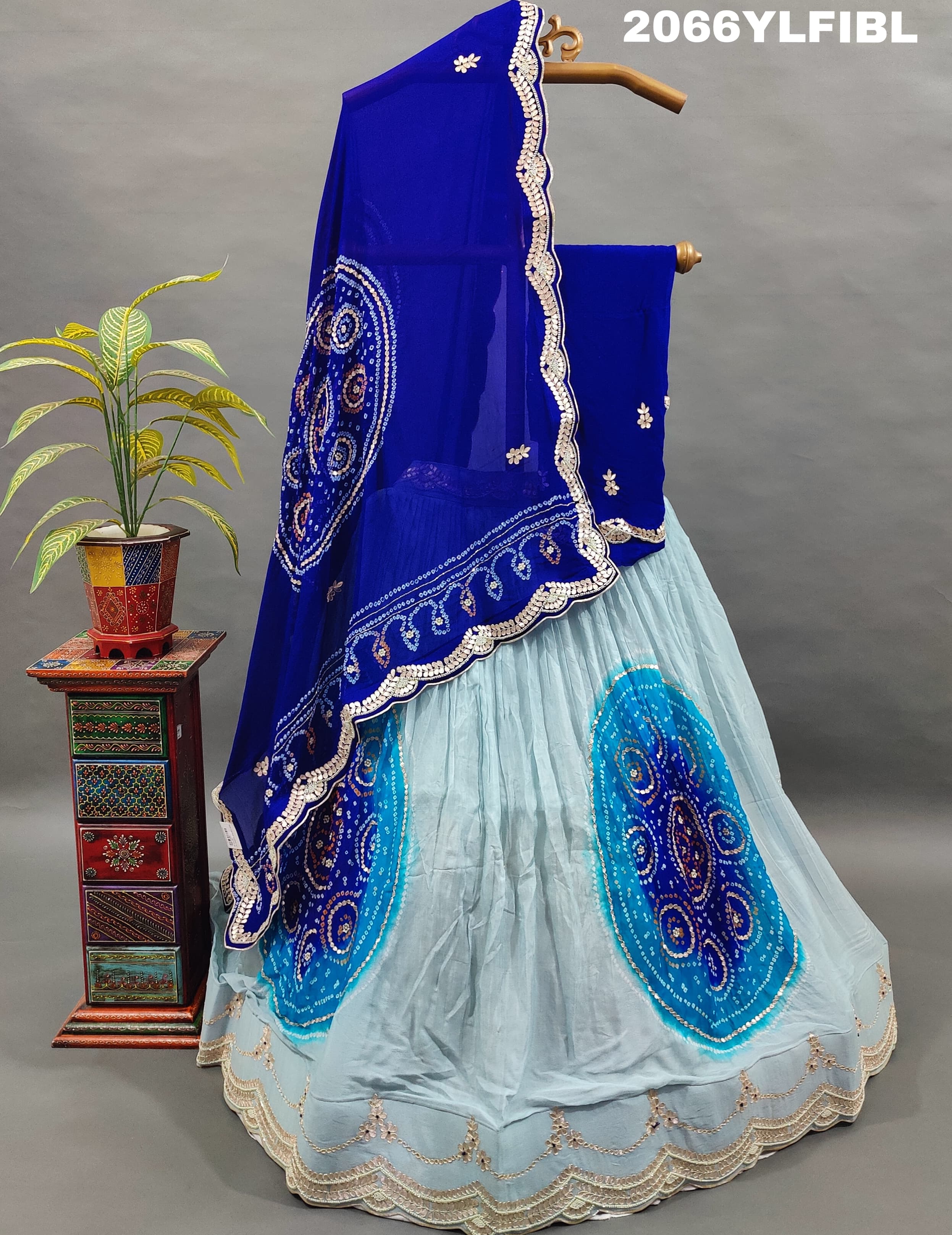 A blue traditional lehenga with gota patti work and bandhani style