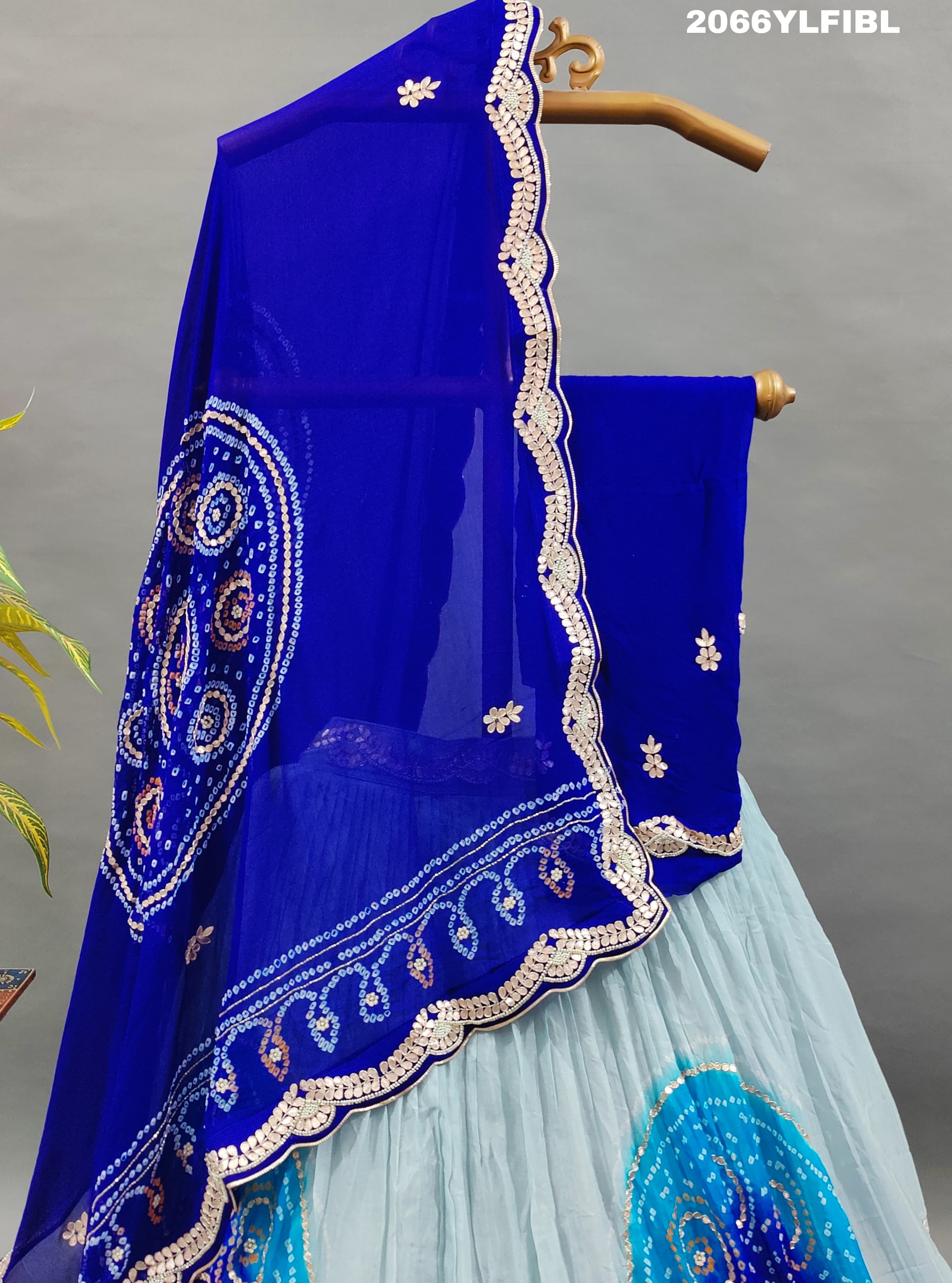 A blue traditional lehenga with gota patti work and bandhani style