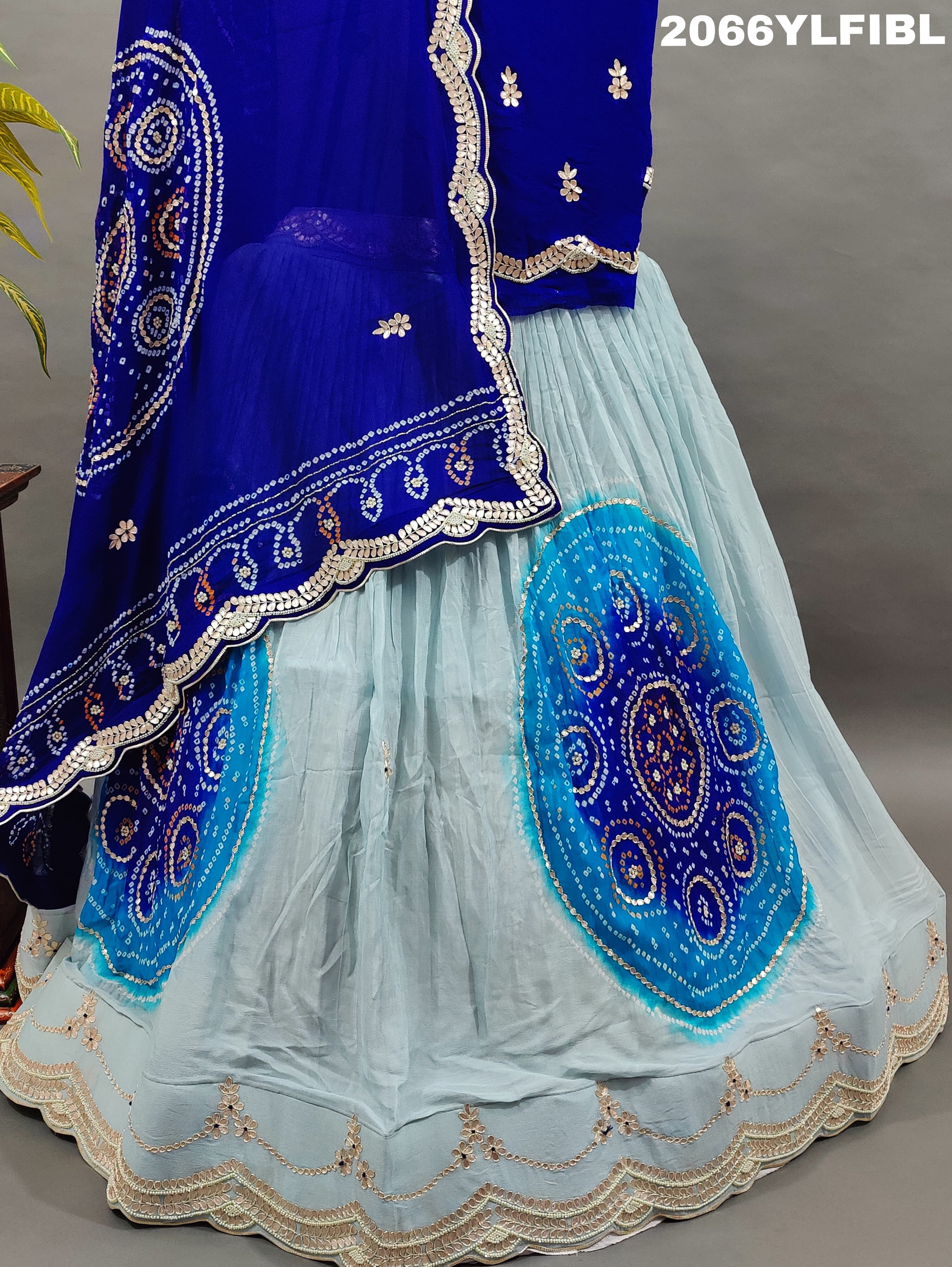 A blue traditional lehenga with gota patti work and bandhani style