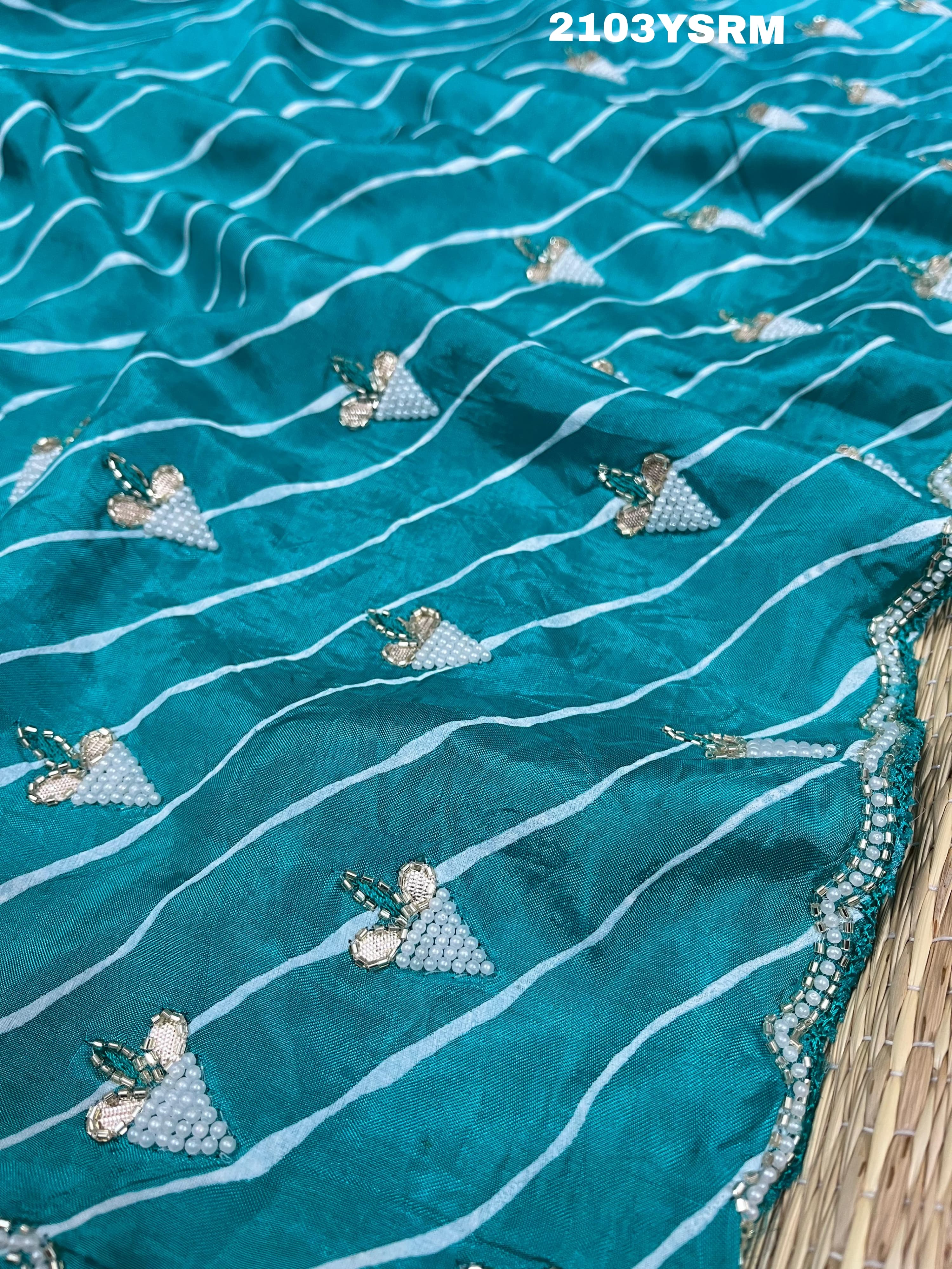 Ablue and white Dola silk saree with pearl embellishments and gota work