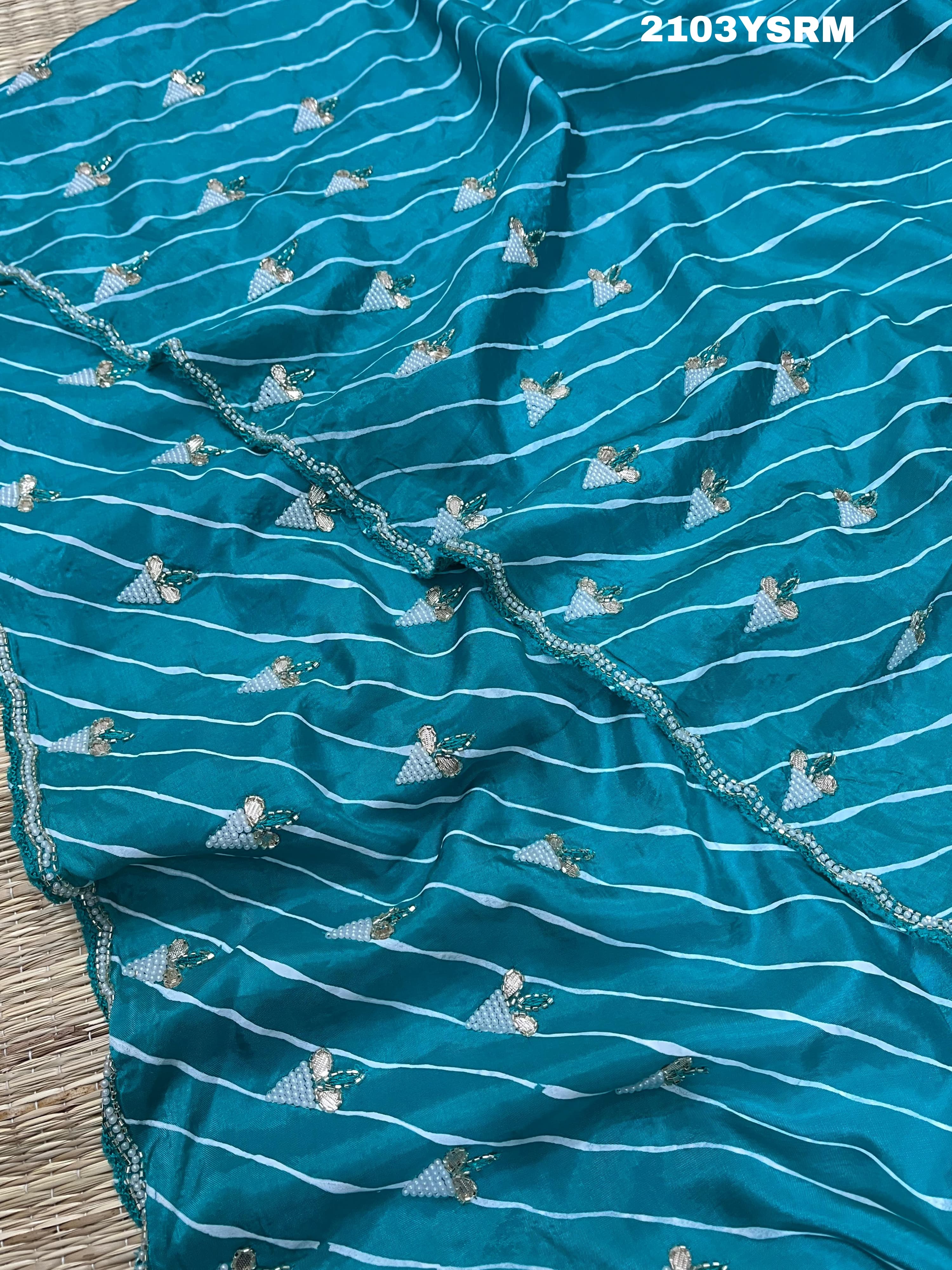 Ablue and white Dola silk saree with pearl embellishments and gota work
