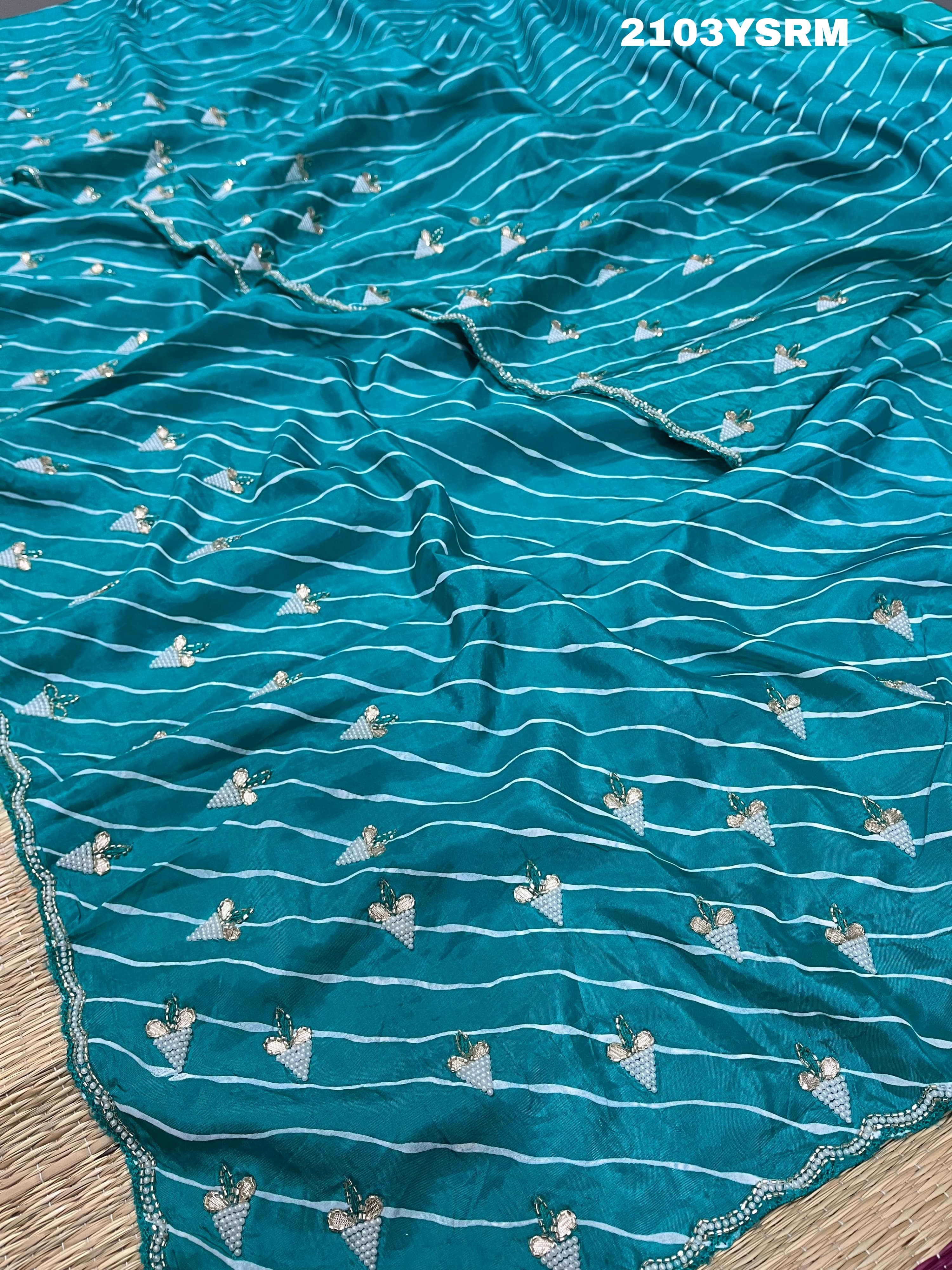 Ablue and white Dola silk saree with pearl embellishments and gota work