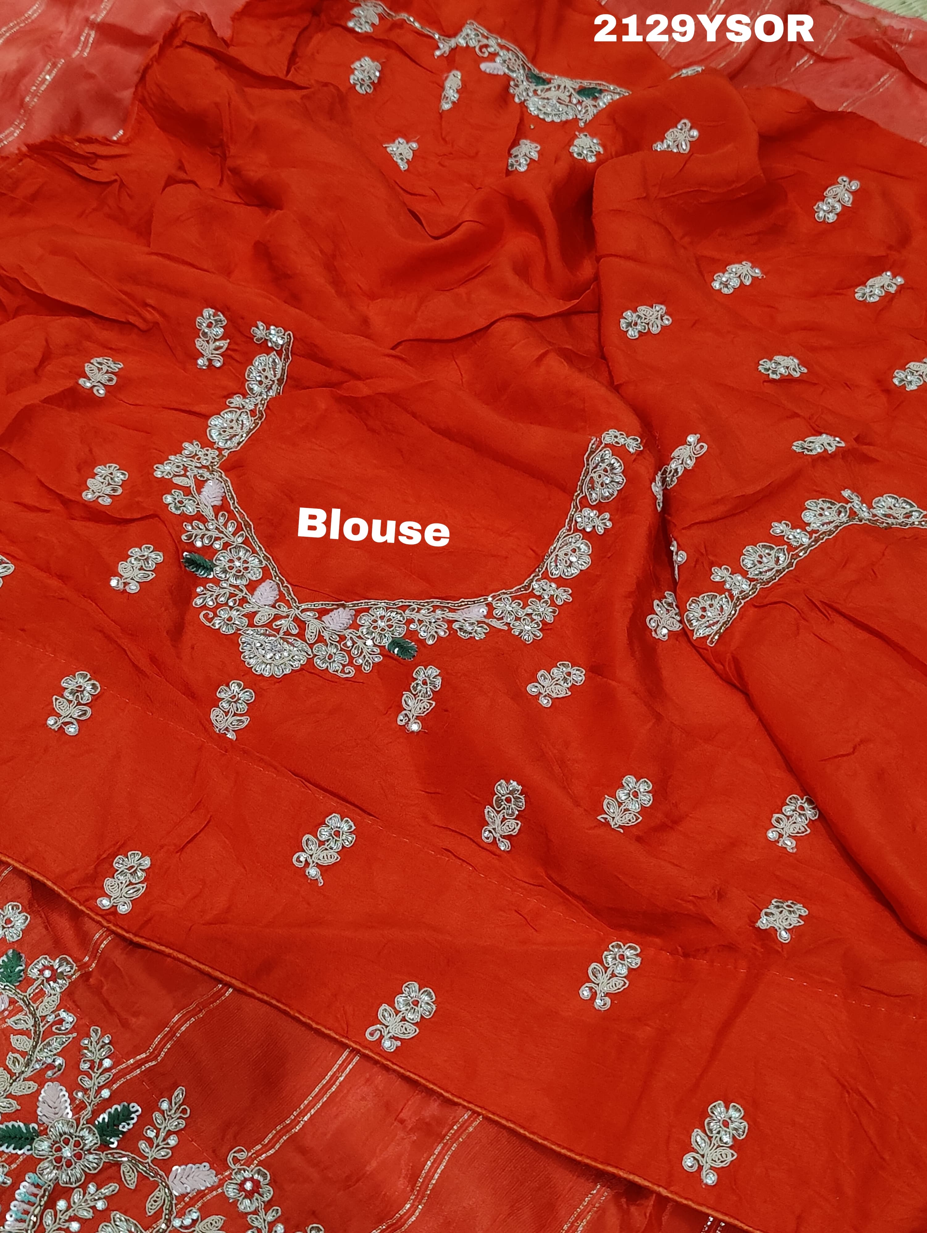 A red saree with silver and gold sequence cutdana work pattern.